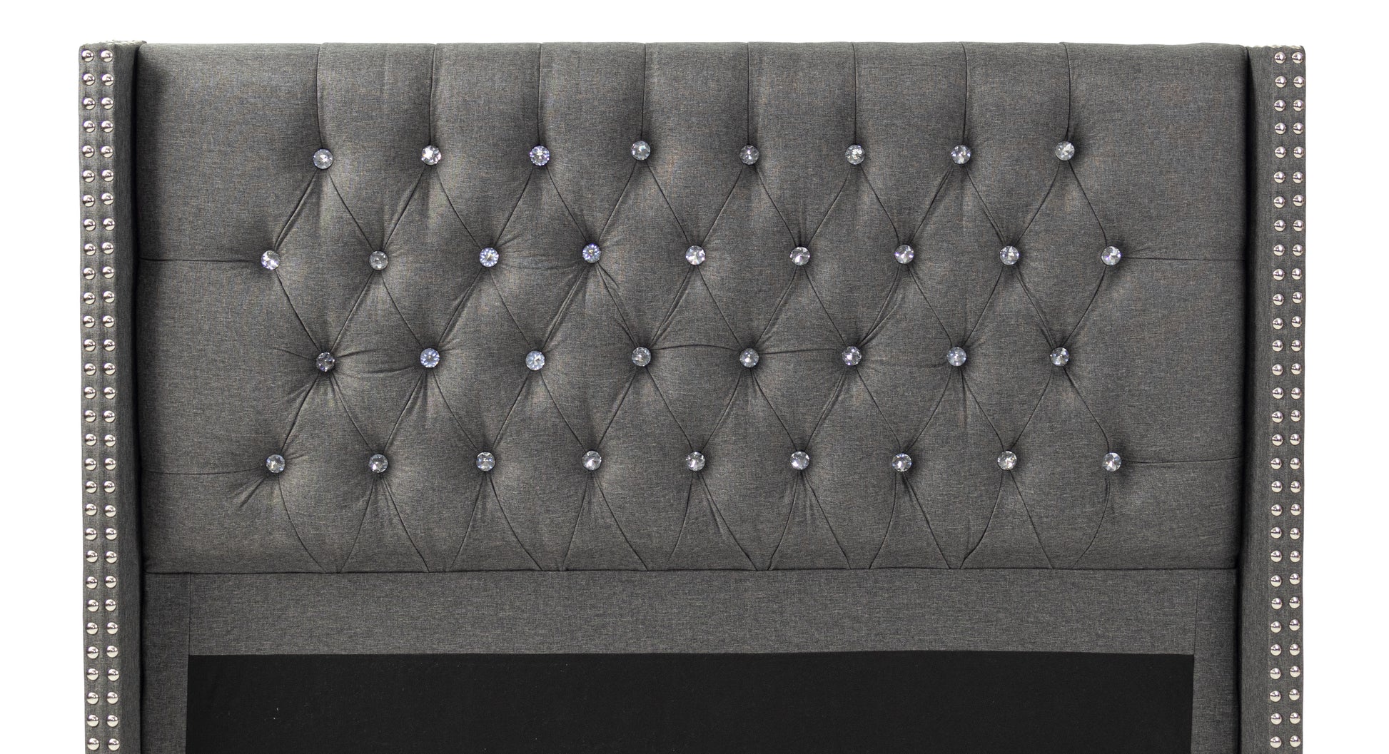 Dark gray tufted headboard with crystal accents and silver nailhead trim