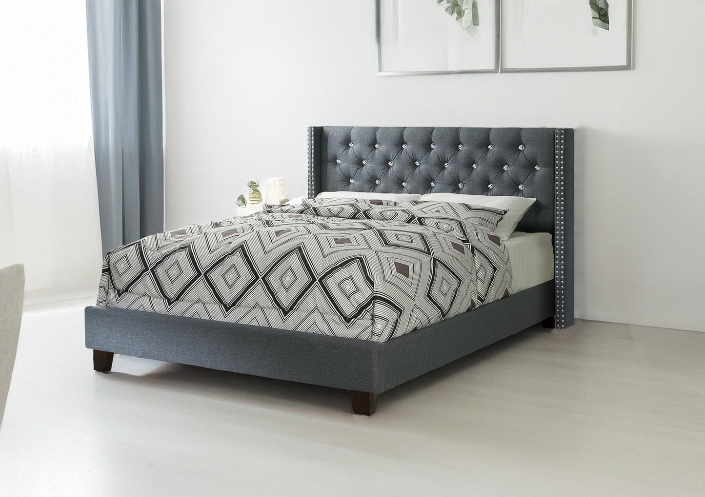 Elegant grey tufted bed frame with crystal accents and diamond pattern bedding