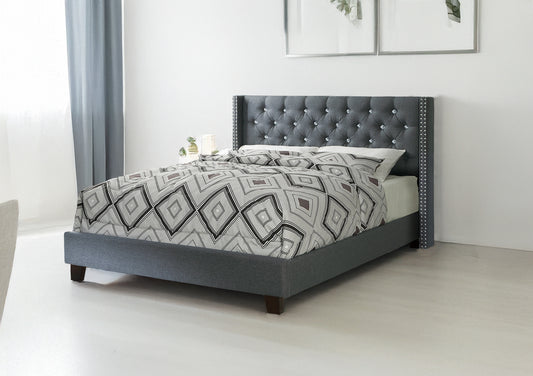 Elegant grey tufted bed frame with crystal accents and diamond pattern bedding