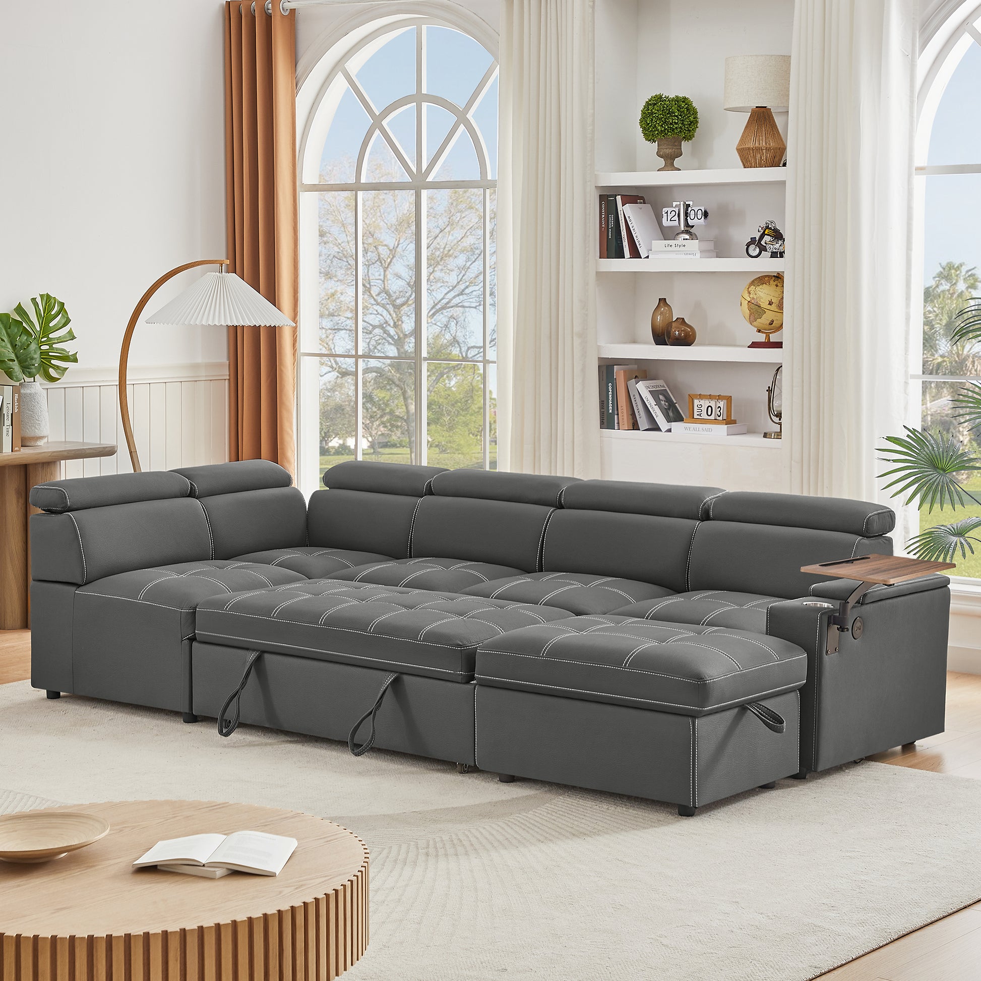 Dark grey sectional sofa with tufted cushions and white contrast stitching for a modern living room