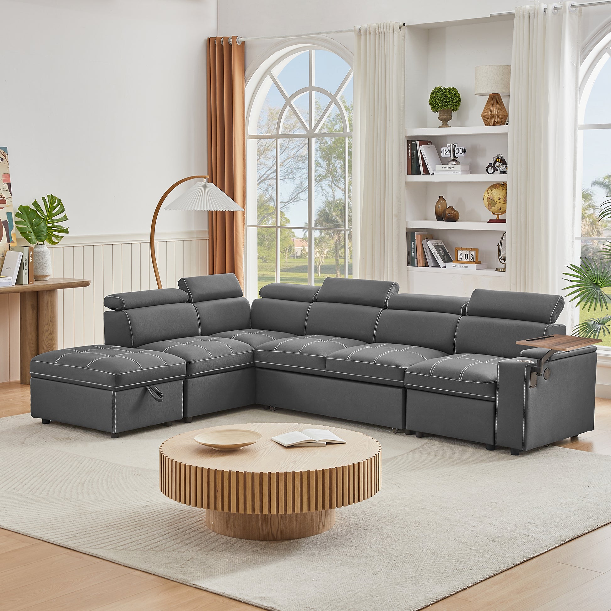 Dark grey sectional sofa with white stitching and builtin storage ideal for modern living rooms