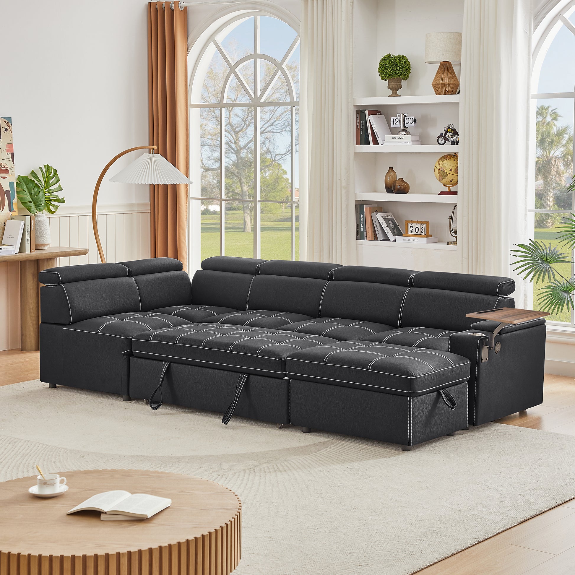 Black sectional sofa with white stitching and pullout bed functionality