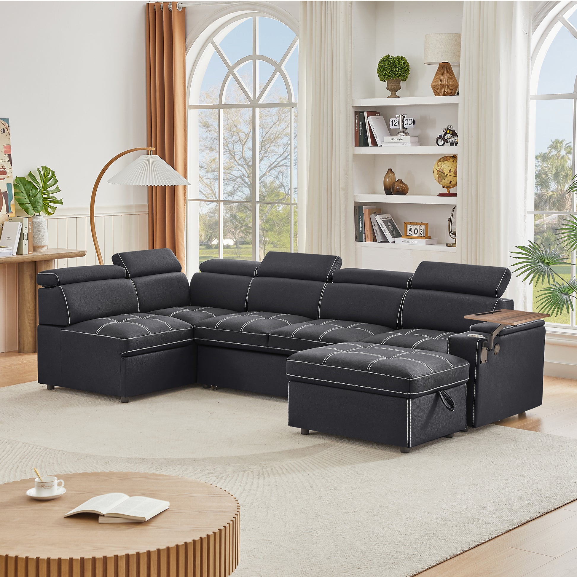 Dark gray sectional sofa with white stitching and storage ottoman