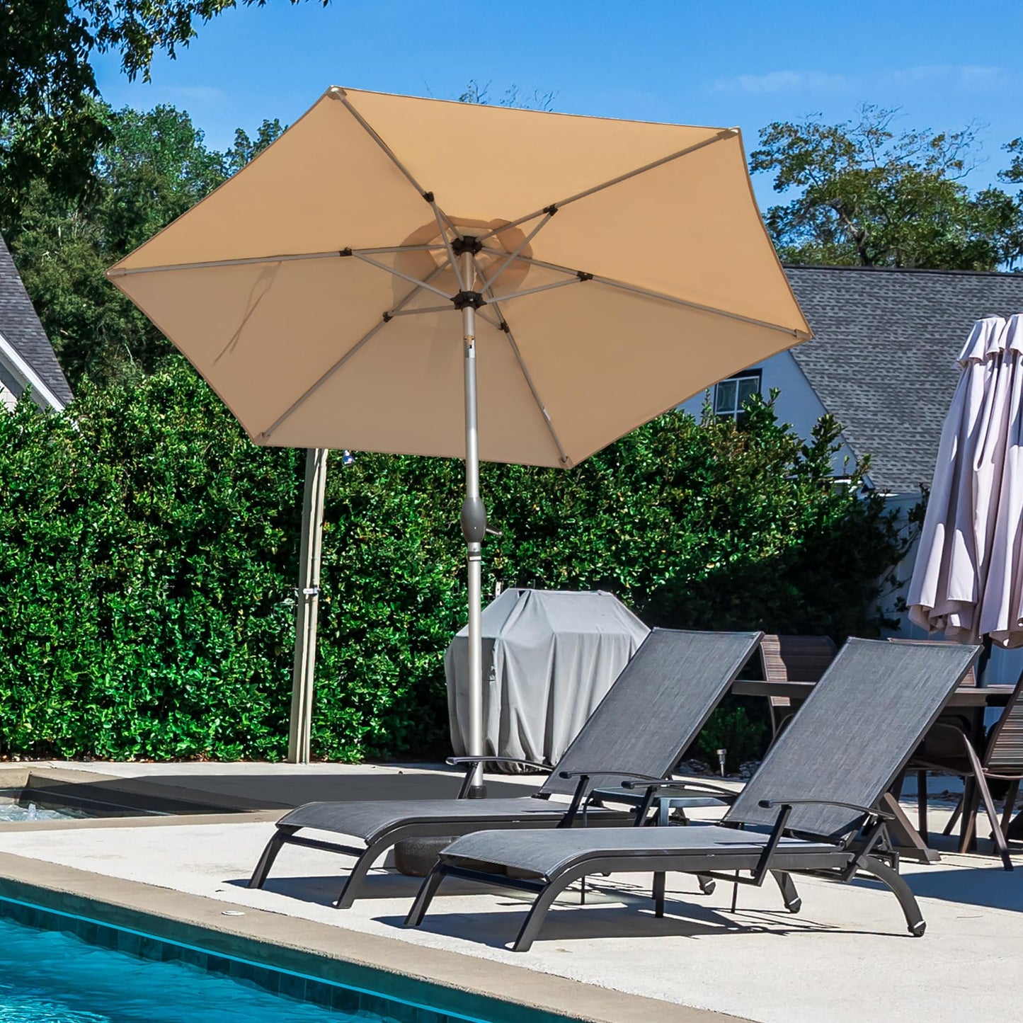 Large octagonal patio umbrella in beige fabric providing shade for outdoor relaxation