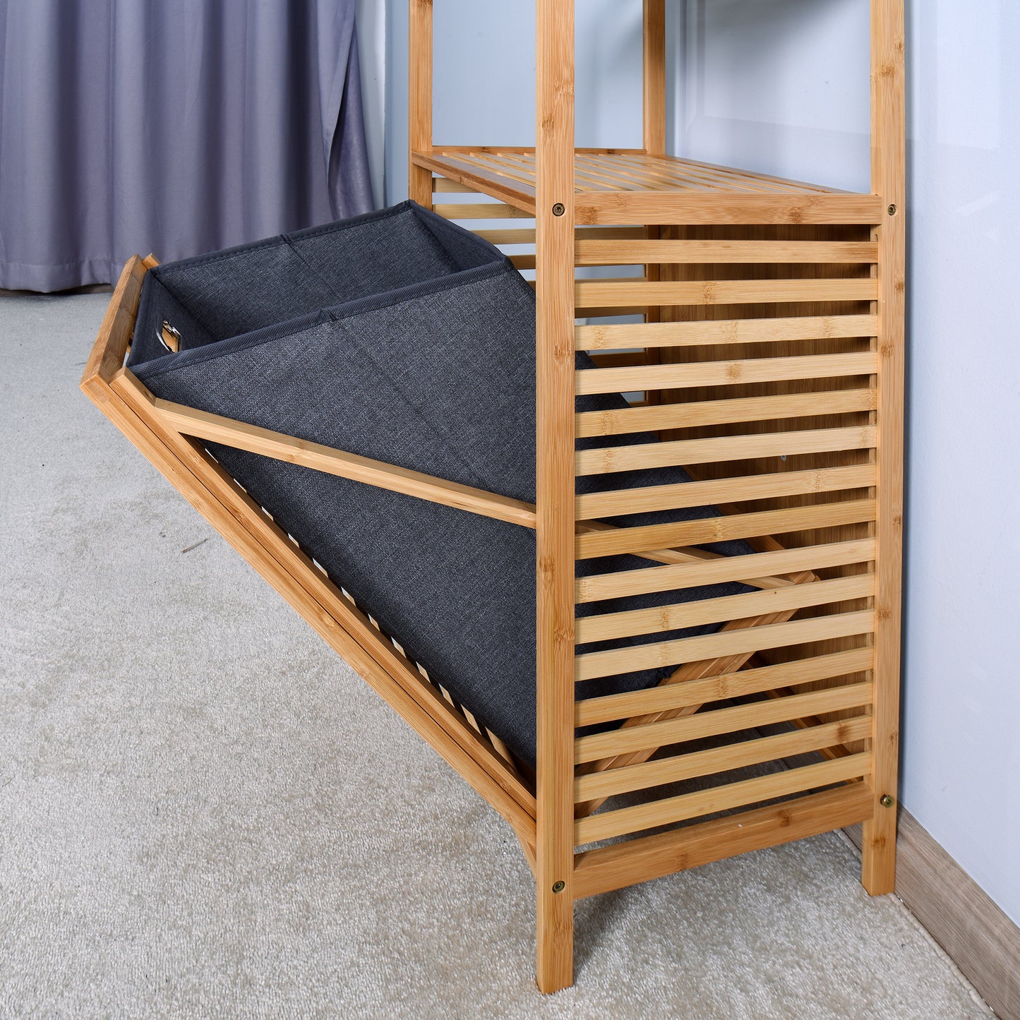 Dark gray fabric laundry basket on a slatted bamboo shelving unit
