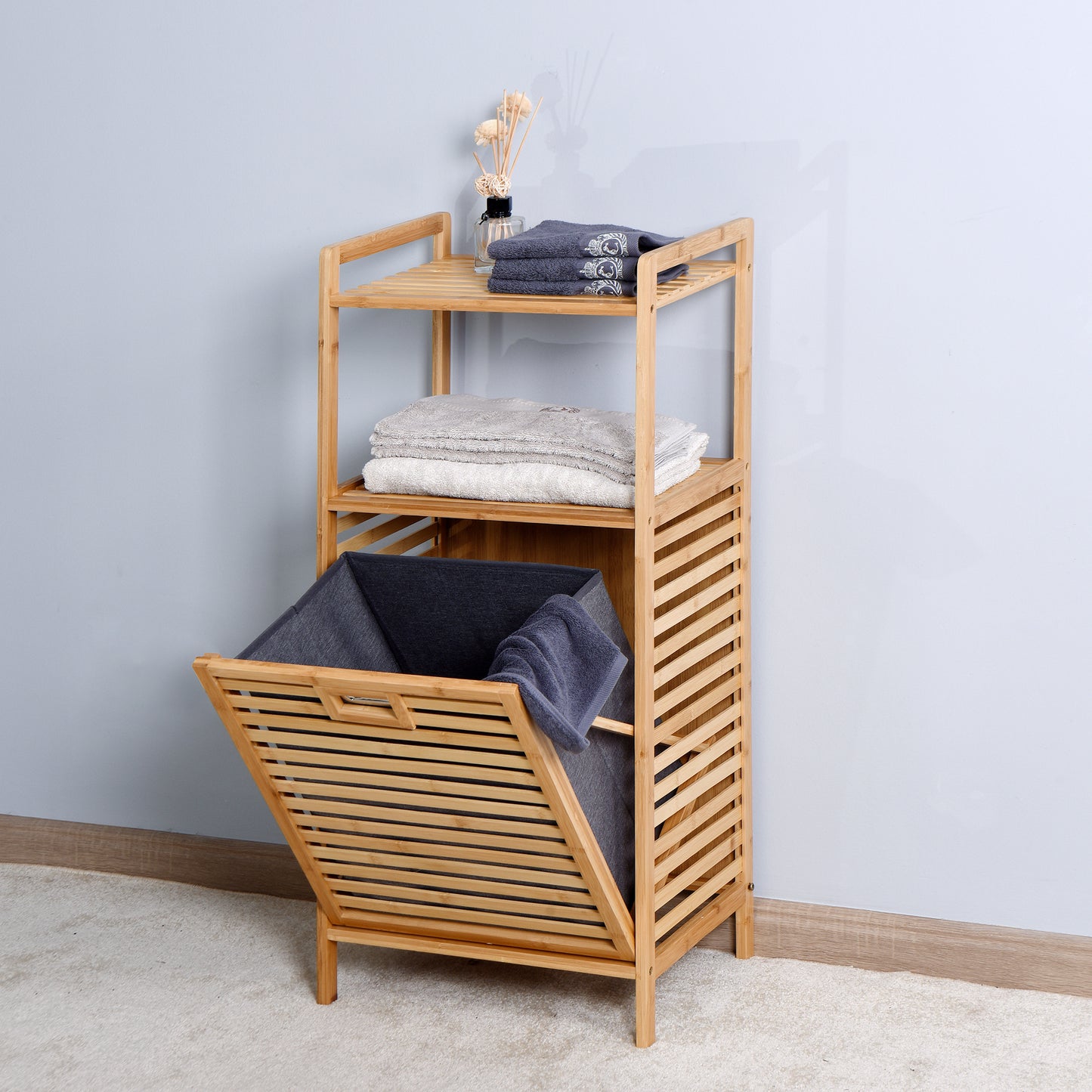 Wooden bathroom organizer with three shelves holding folded towels