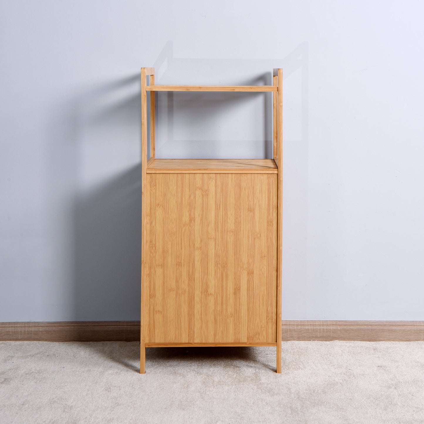 Natural bamboo bathroom shelf unit with two open shelves and one enclosed cabinet space