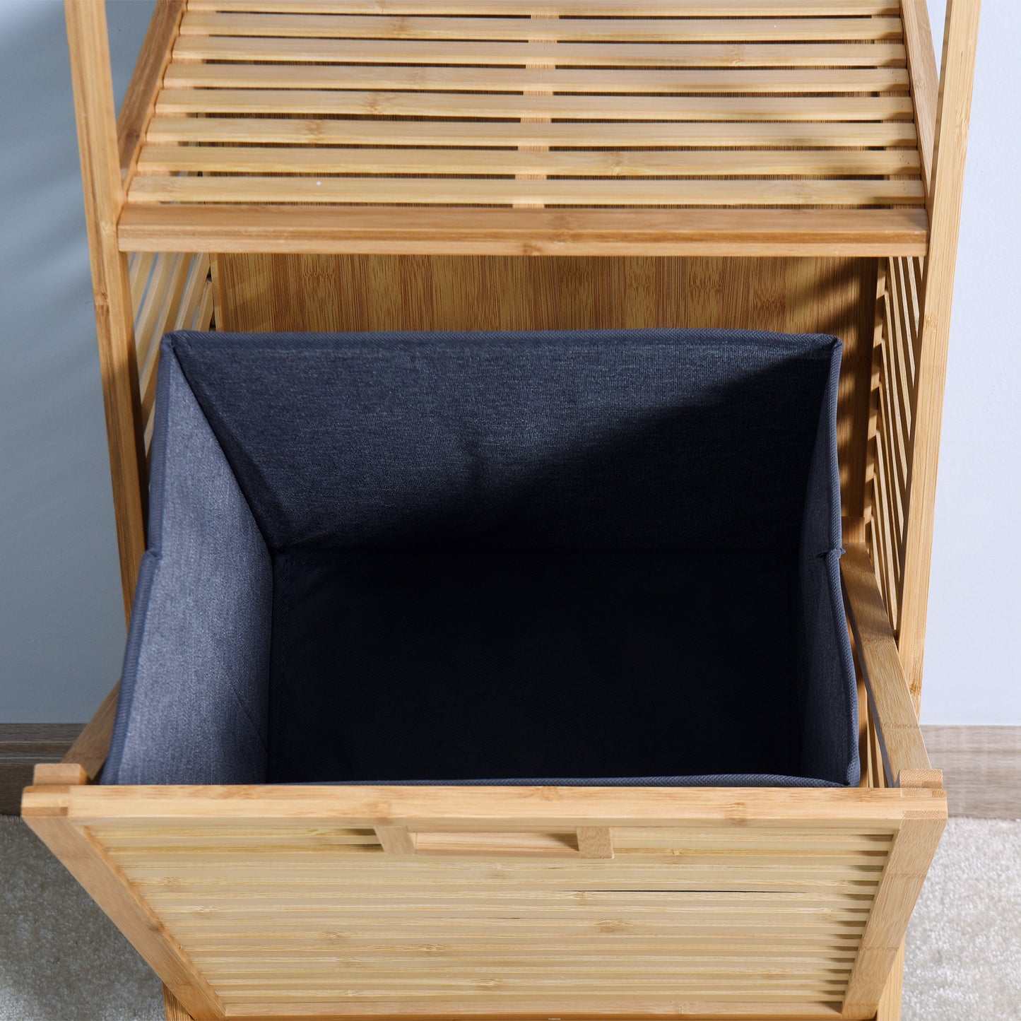 Natural bamboo laundry basket with grey fabric liner and slatted design