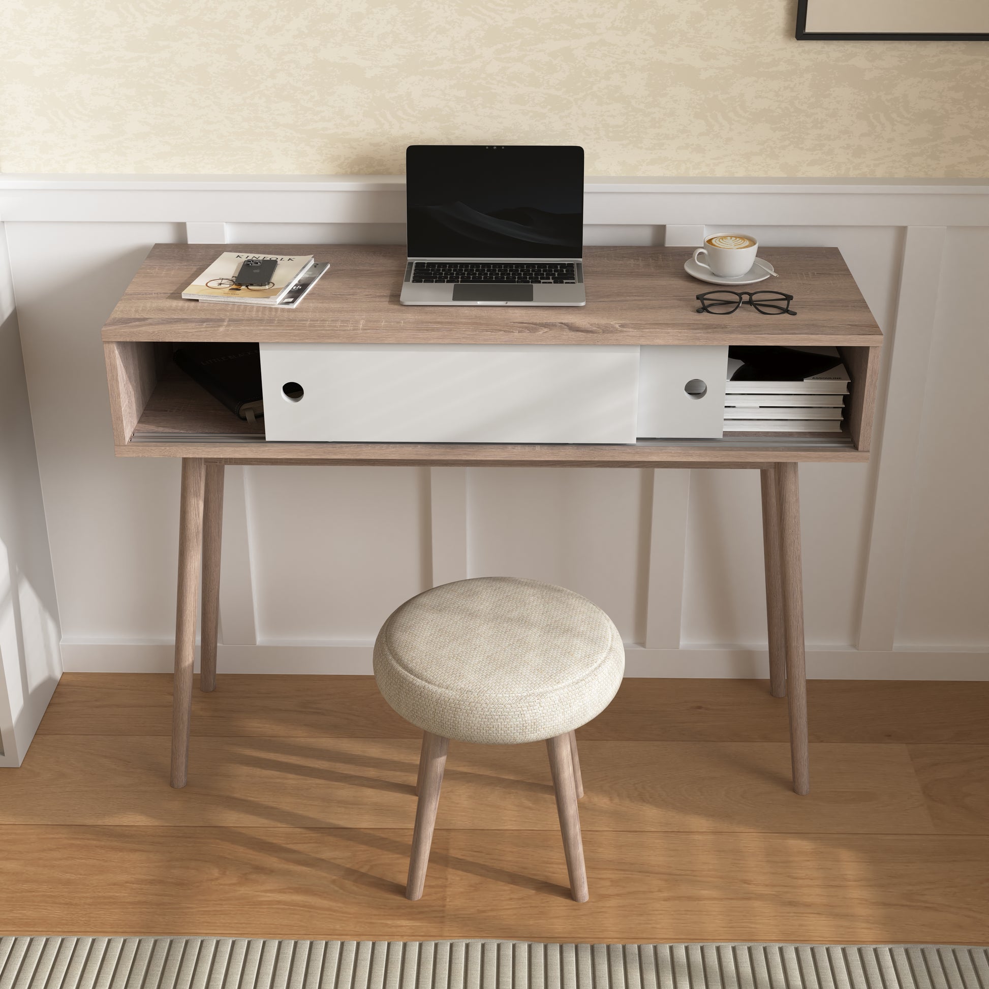 Light oak midcentury modern writing desk with laptop and coffee cup