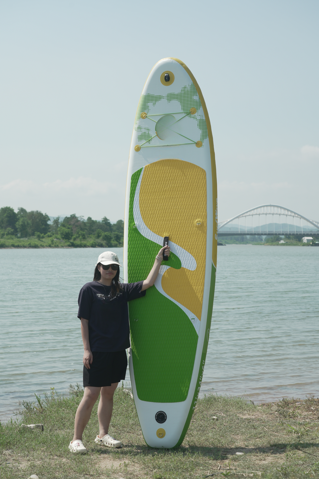 Inflatable stand up paddleboard with green and yellow accents