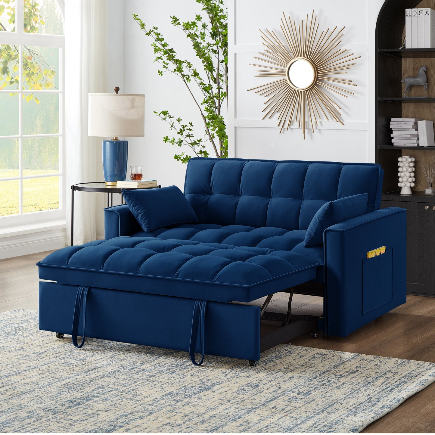 Navy blue velvet sofa bed with tufted cushions and storage armrest