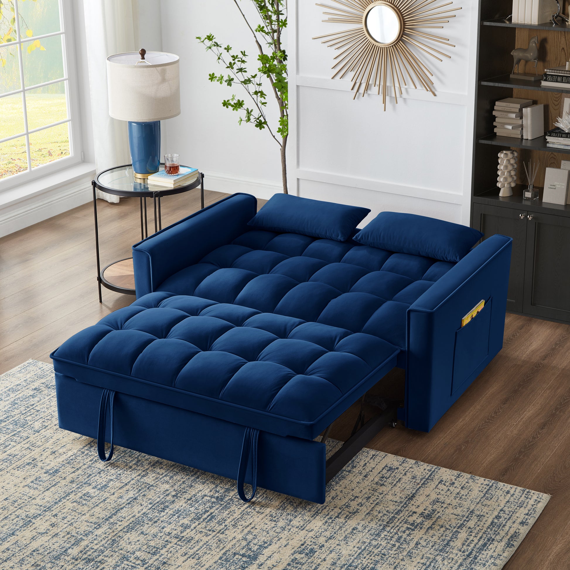 Deep blue velvet sofa bed with tufted cushions and convenient side pockets