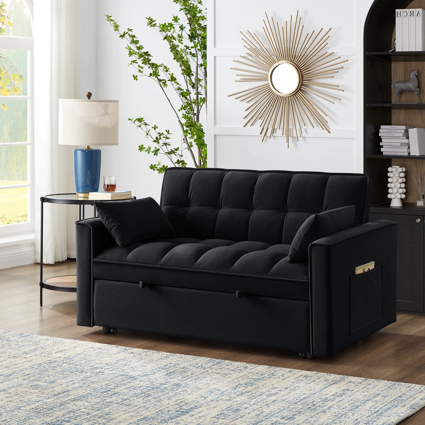 Plush black velvet sofa bed with tufted cushions and convenient side pocket for storage