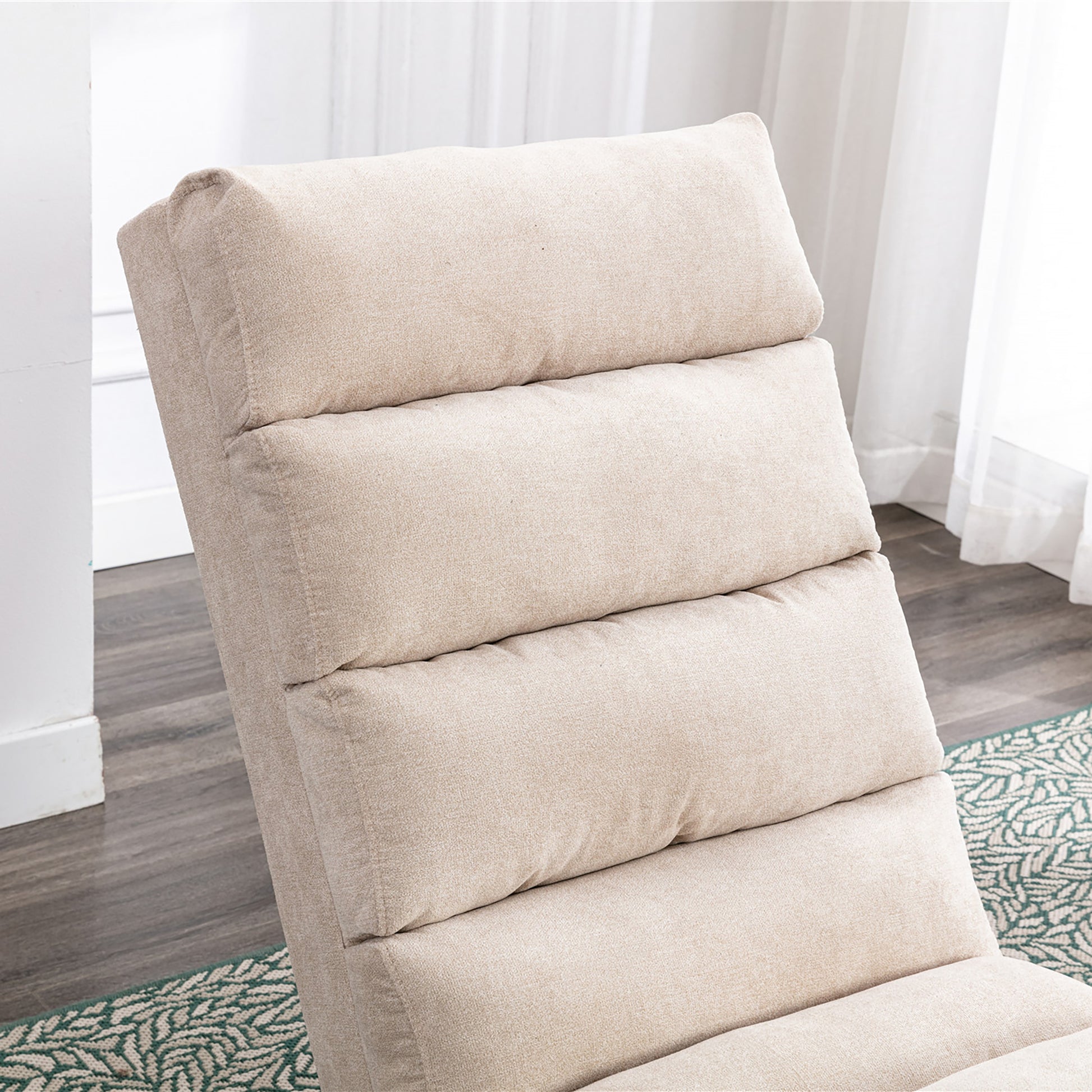 Closeup of a beige fabric recliner chairs padded seat and back cushions