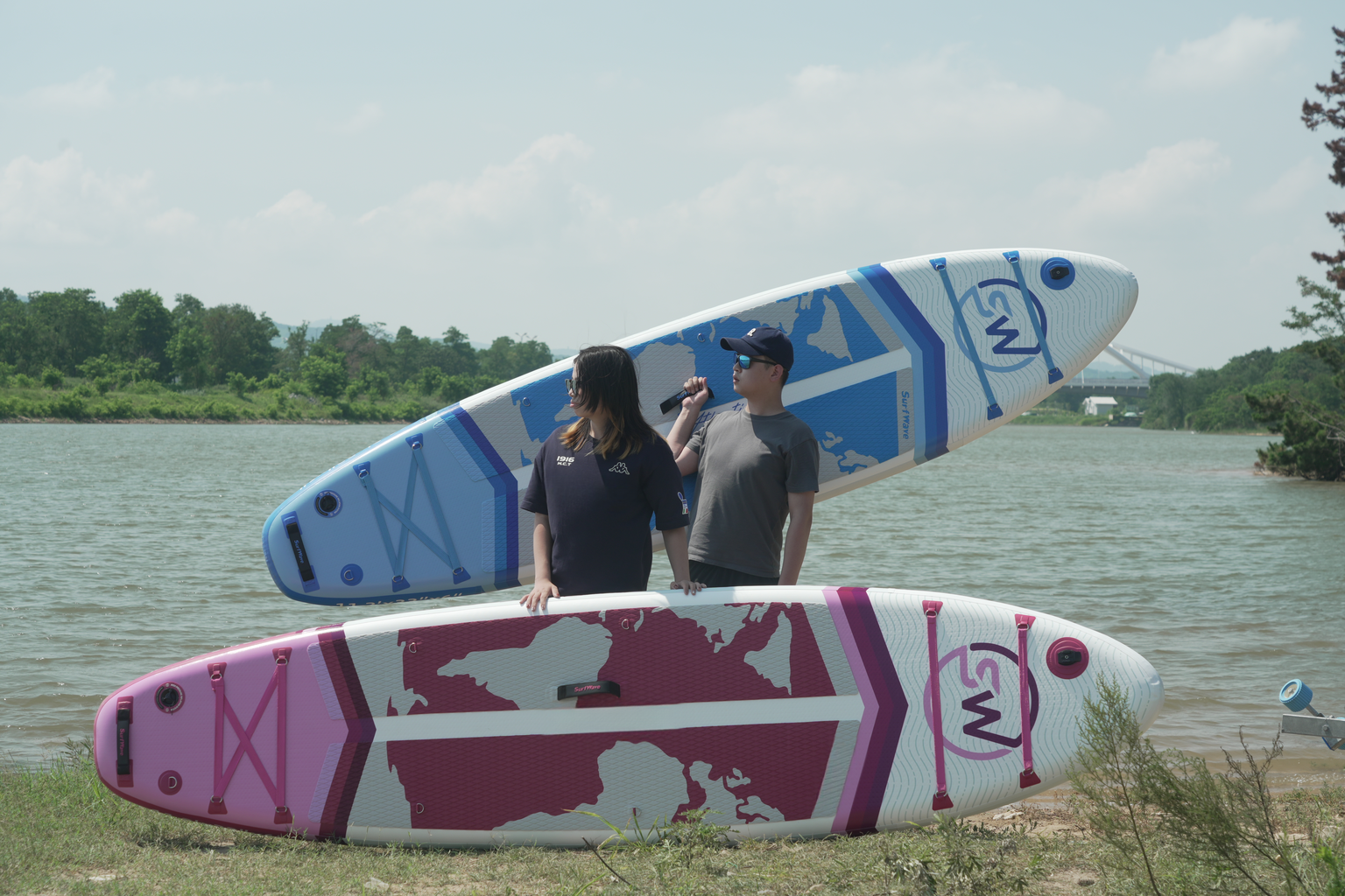 Pink and white paddleboard with world map graphic ideal for water sports