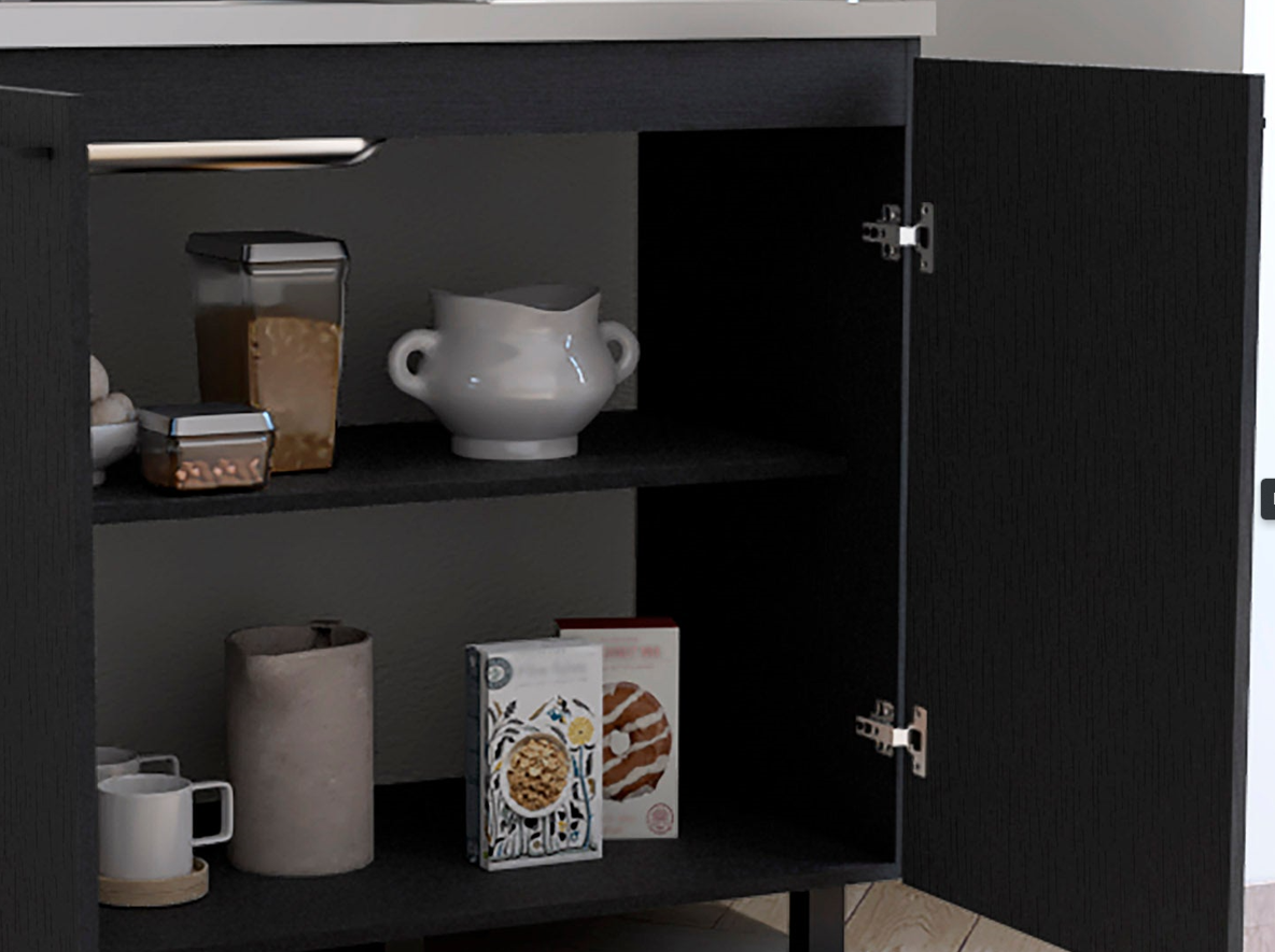 Black kitchen cabinet interior showing storage jars and ceramic bowl on top shelf