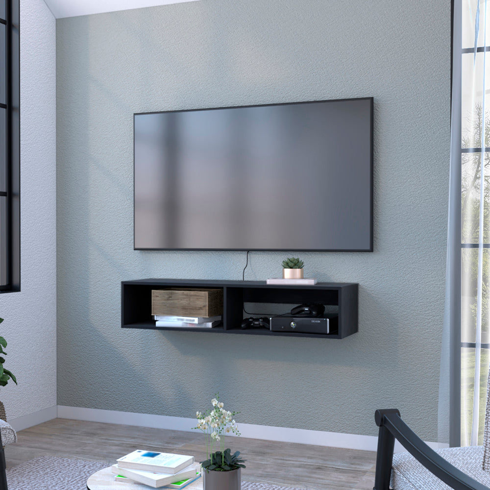 Black floating TV shelf mounted on a textured blue wall with media console