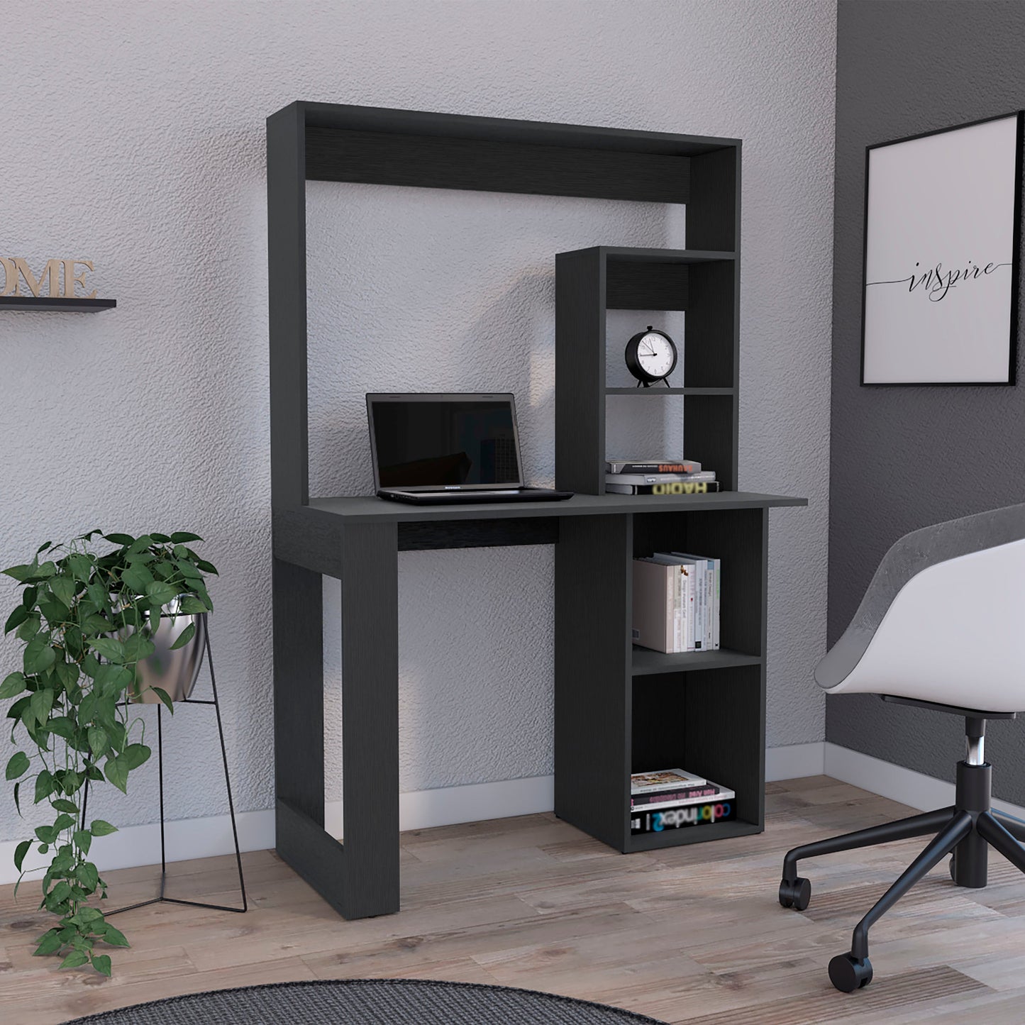 Dark grey modern computer desk with integrated shelving and laptop