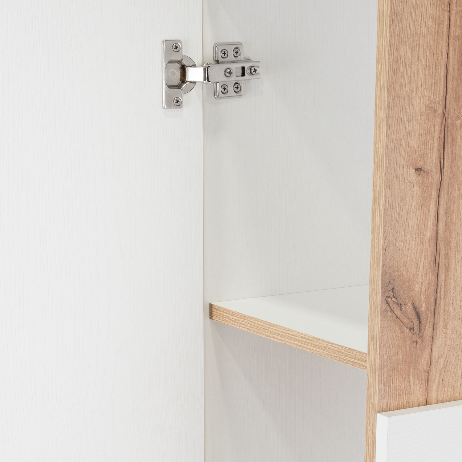 White wood cabinet interior with a silver hinge and a light oak shelf