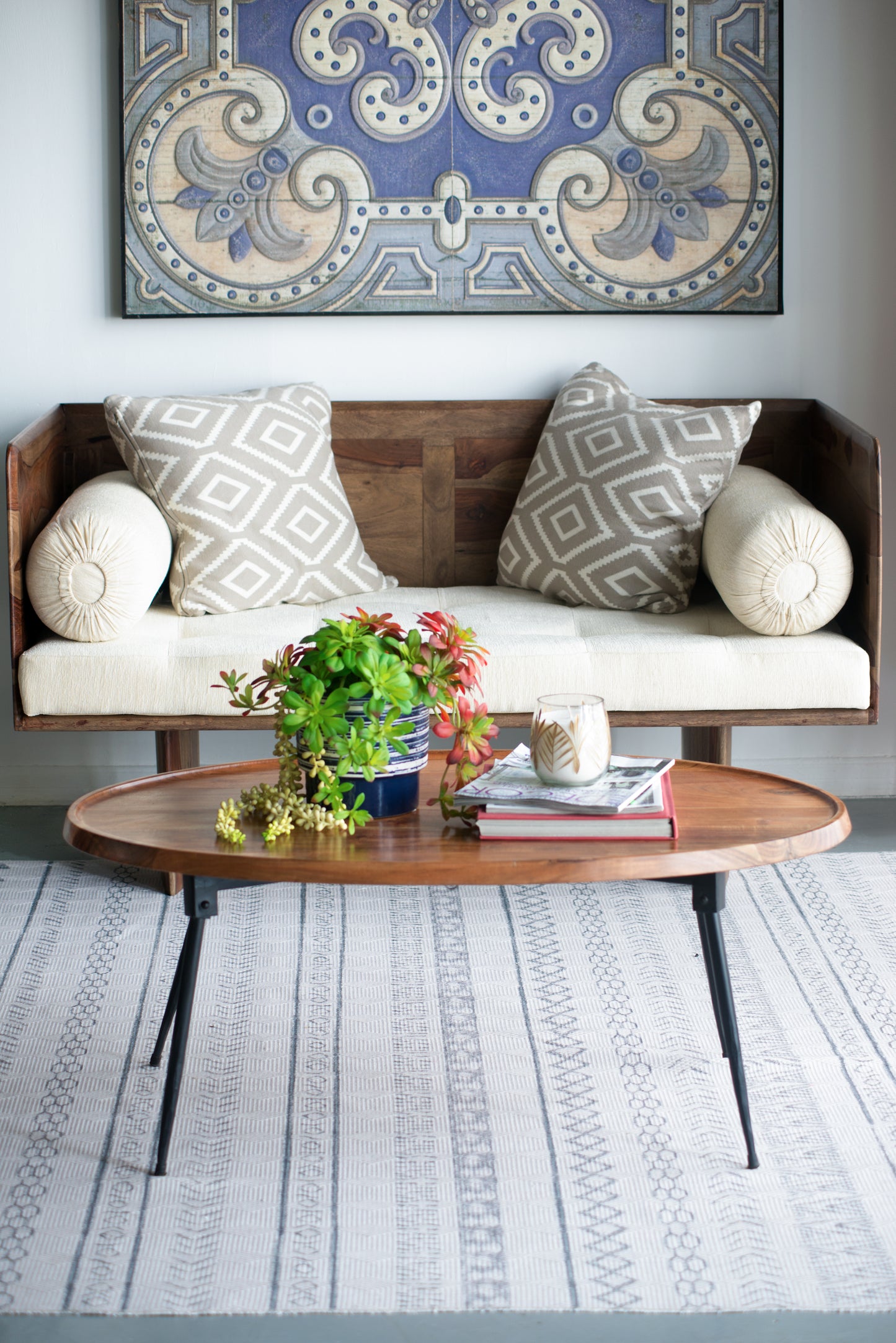 Decorative blue and beige wall art with intricate scrollwork and circular motifs