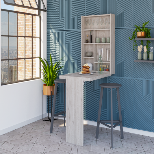 Light wood folding bar table with grey stools and wall shelves holding kitchenware