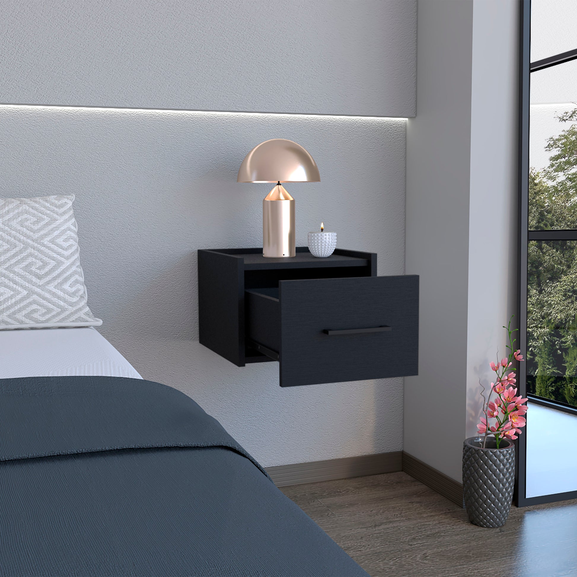 Modern black wallmounted nightstand with one open drawer a copper lamp and candle on top