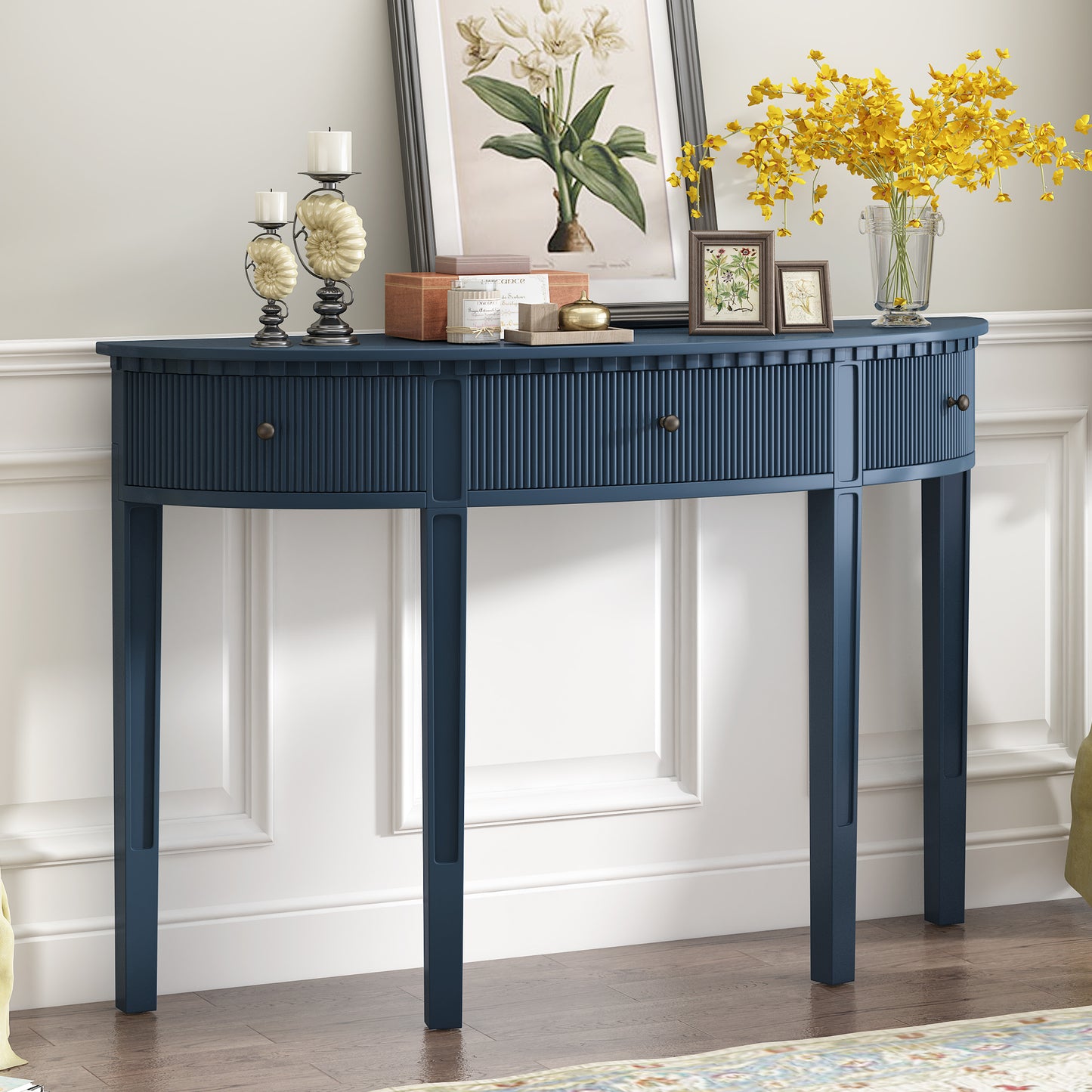 Dark blue fluted hallway console table with three drawers and brass knobs