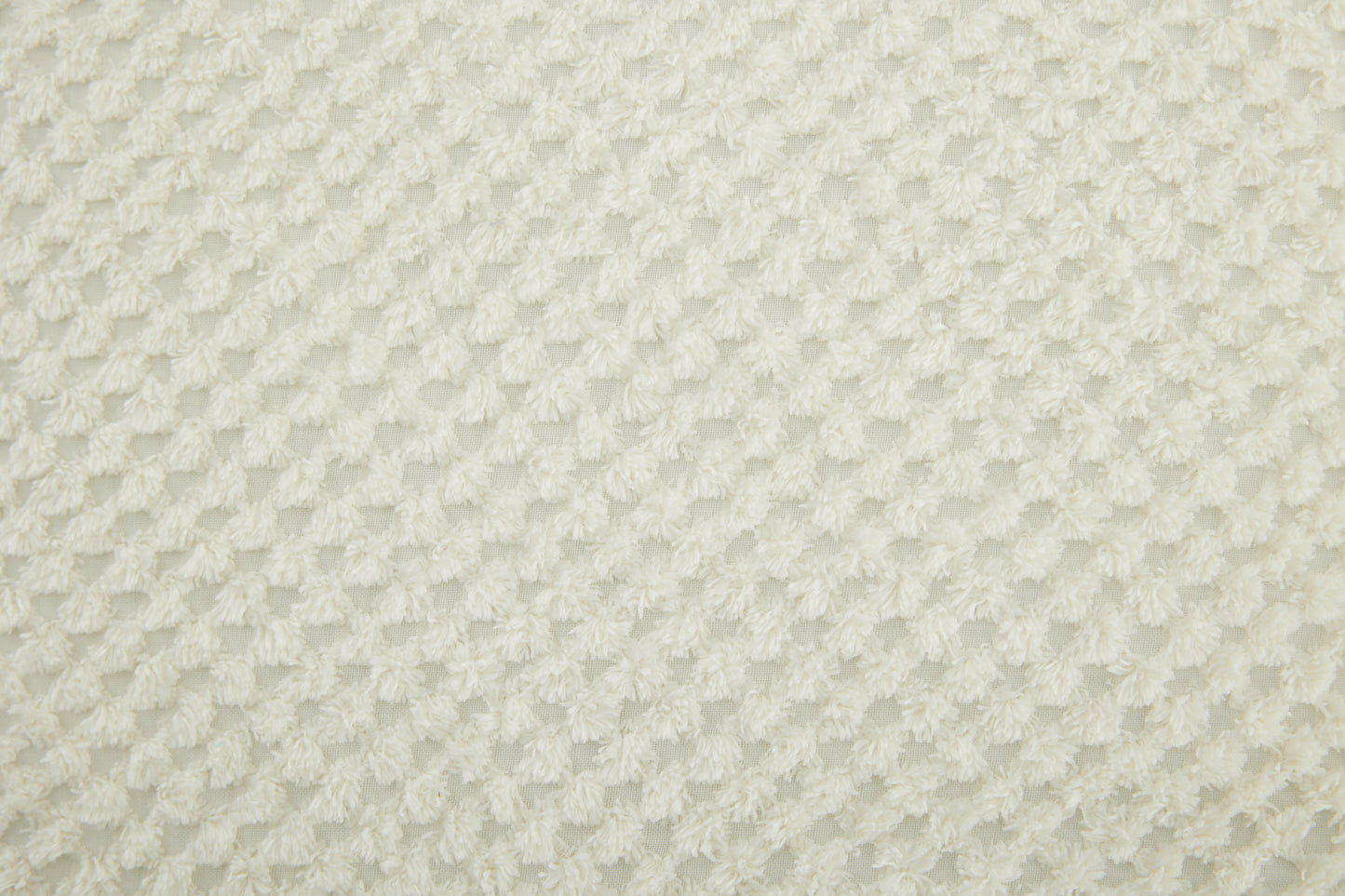 Cream textured fabric with a repeating diamond plush pattern