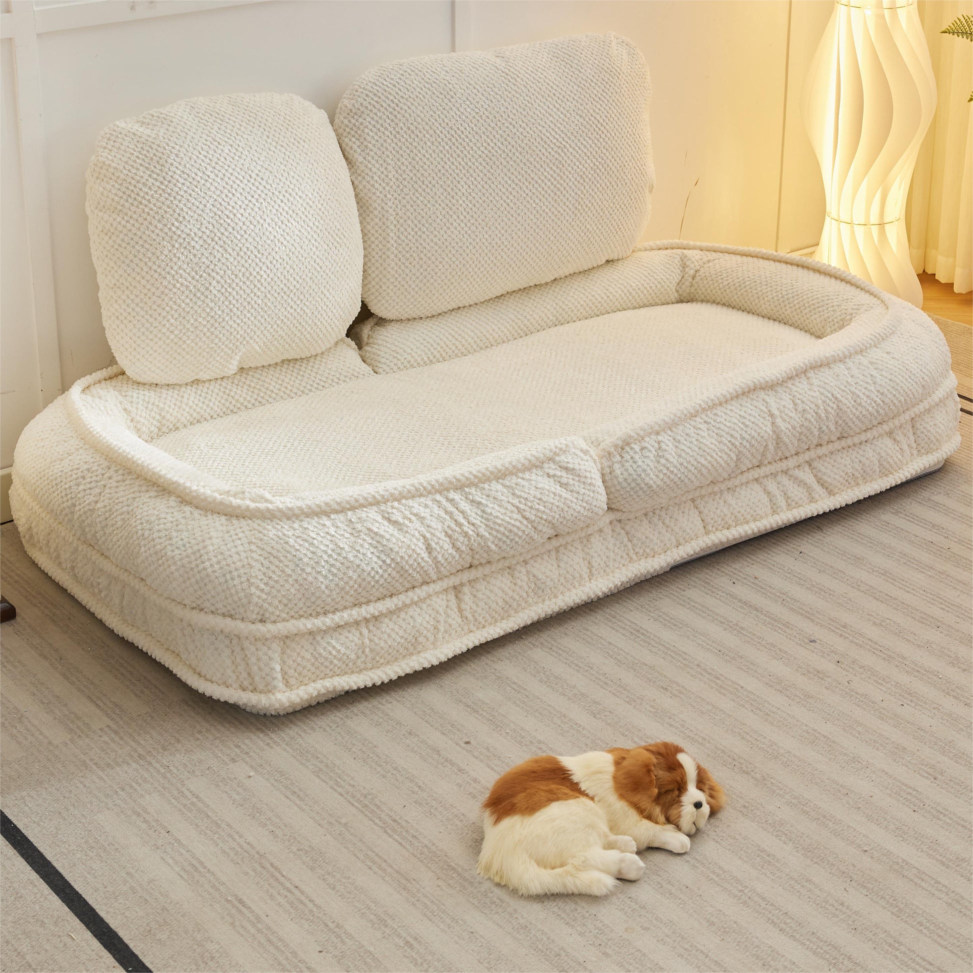 Plush ivory pet bed with a textured knit fabric and raised bolsters perfect for cozy naps