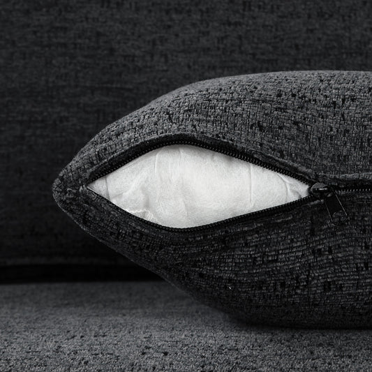 Dark gray textured throw pillow with visible white stuffing and black zipper detail