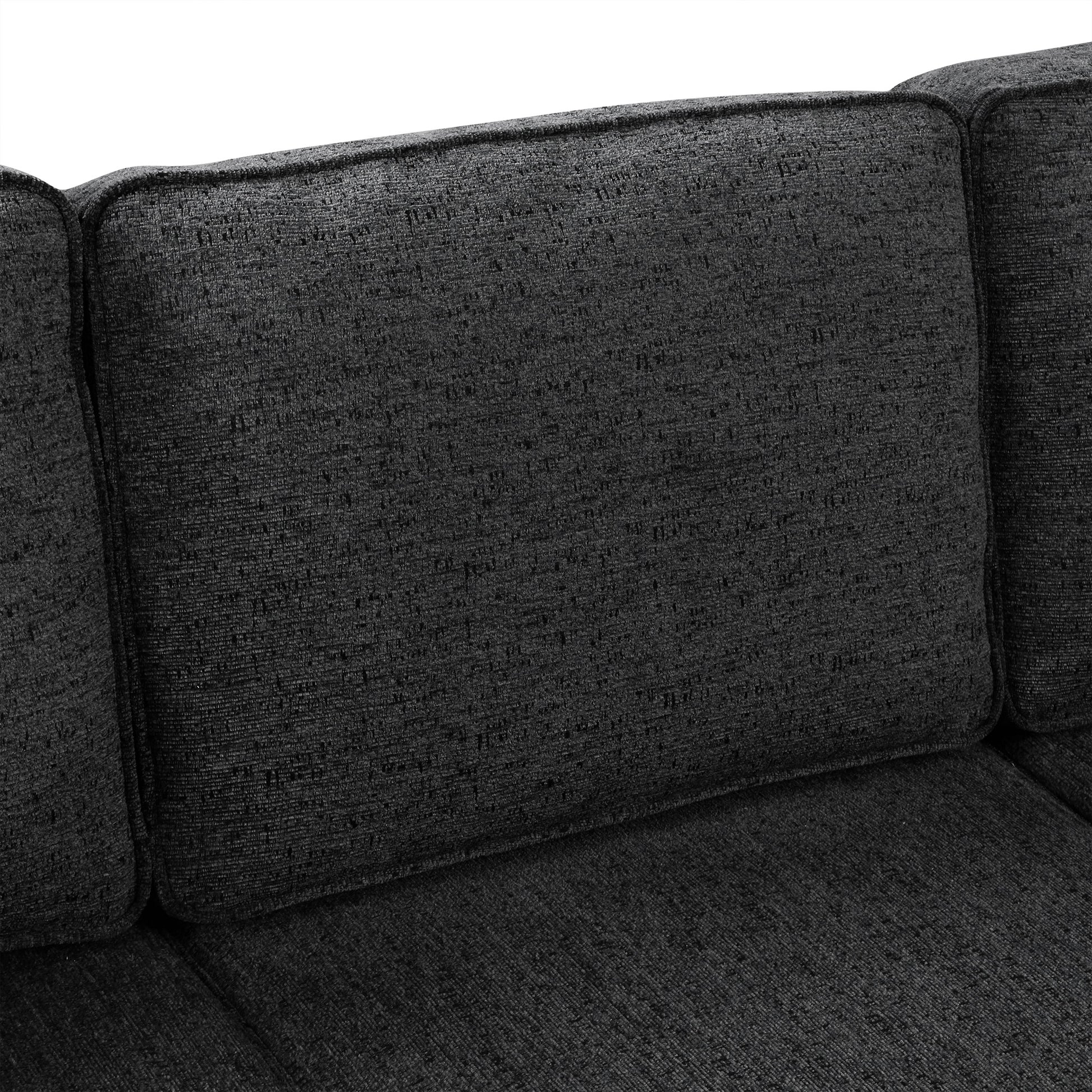 Closeup of dark grey textured fabric sofa cushions modern living room style