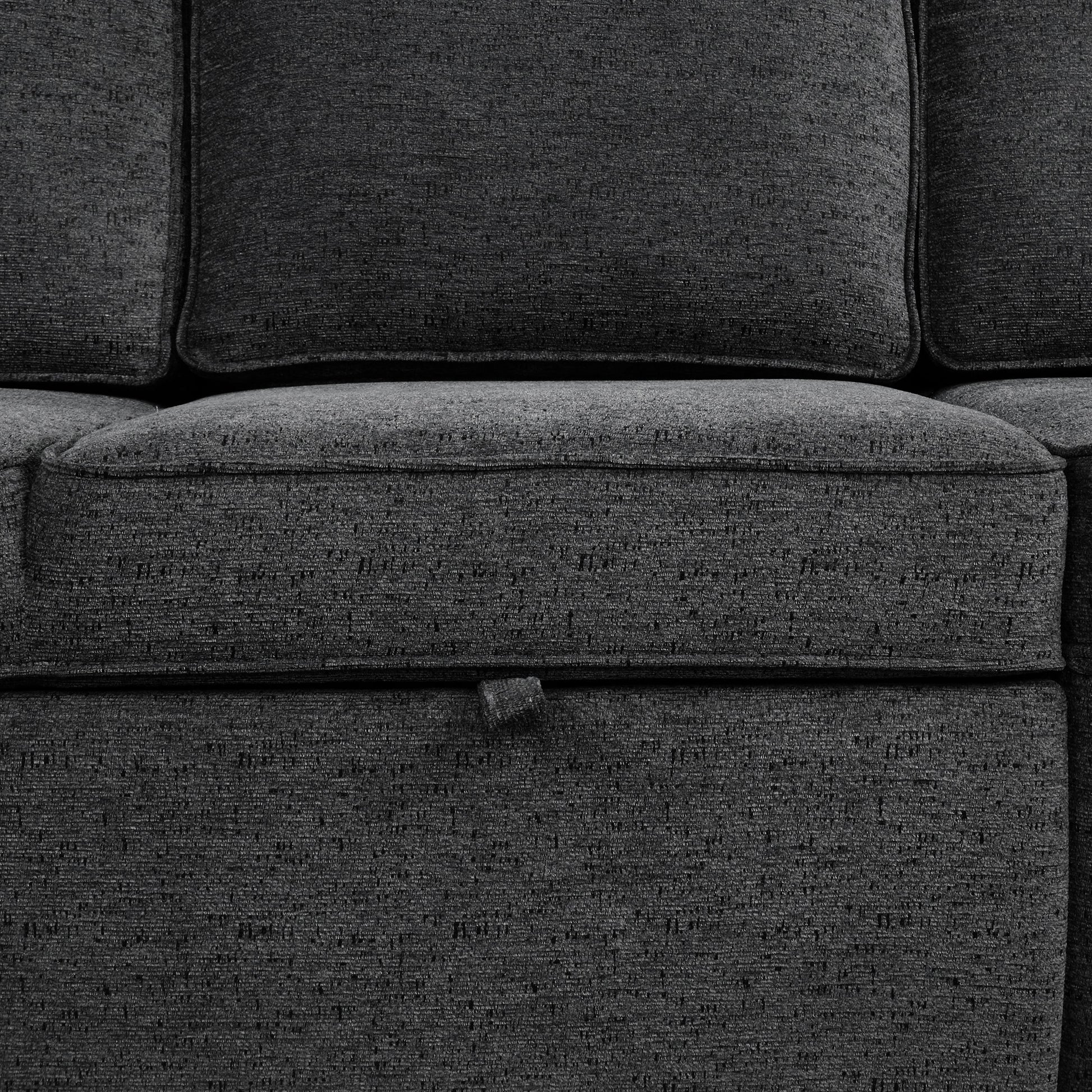 Closeup of dark gray textured fabric sofa cushion with subtle weave pattern
