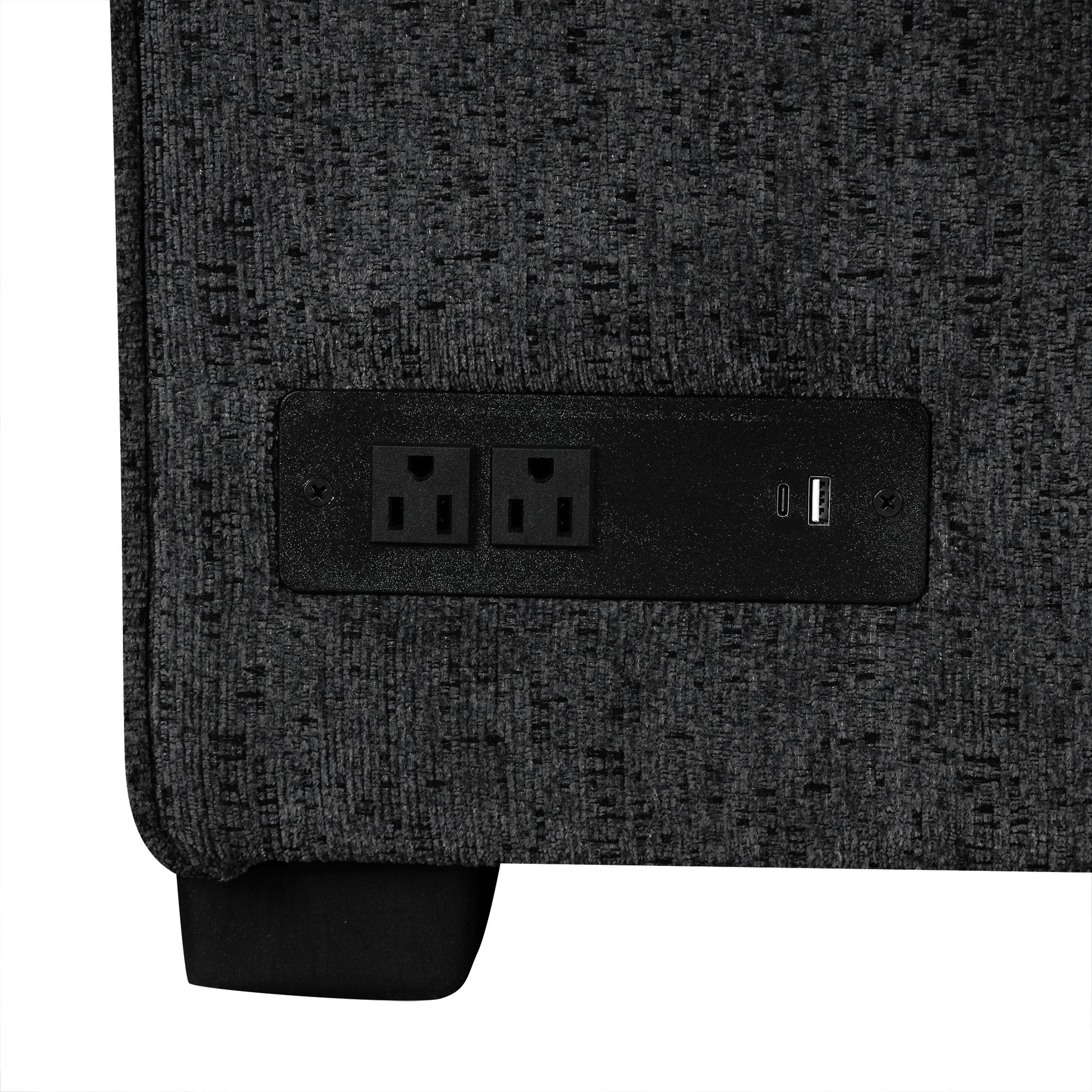 Closeup of a charcoal grey fabric armchair with a builtin power outlet and USB port