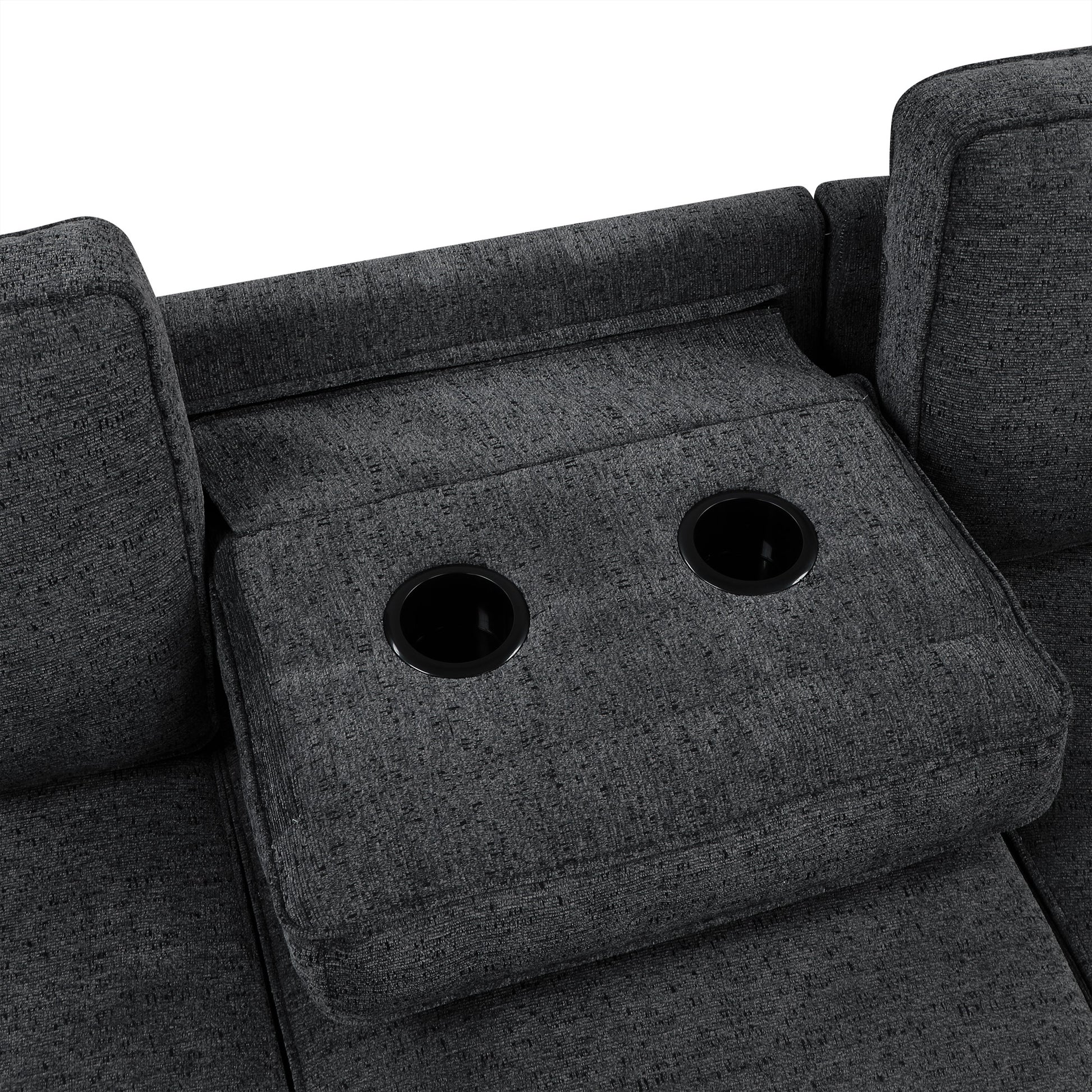 Closeup of a dark gray fabric sofa armrest with two integrated cup holders