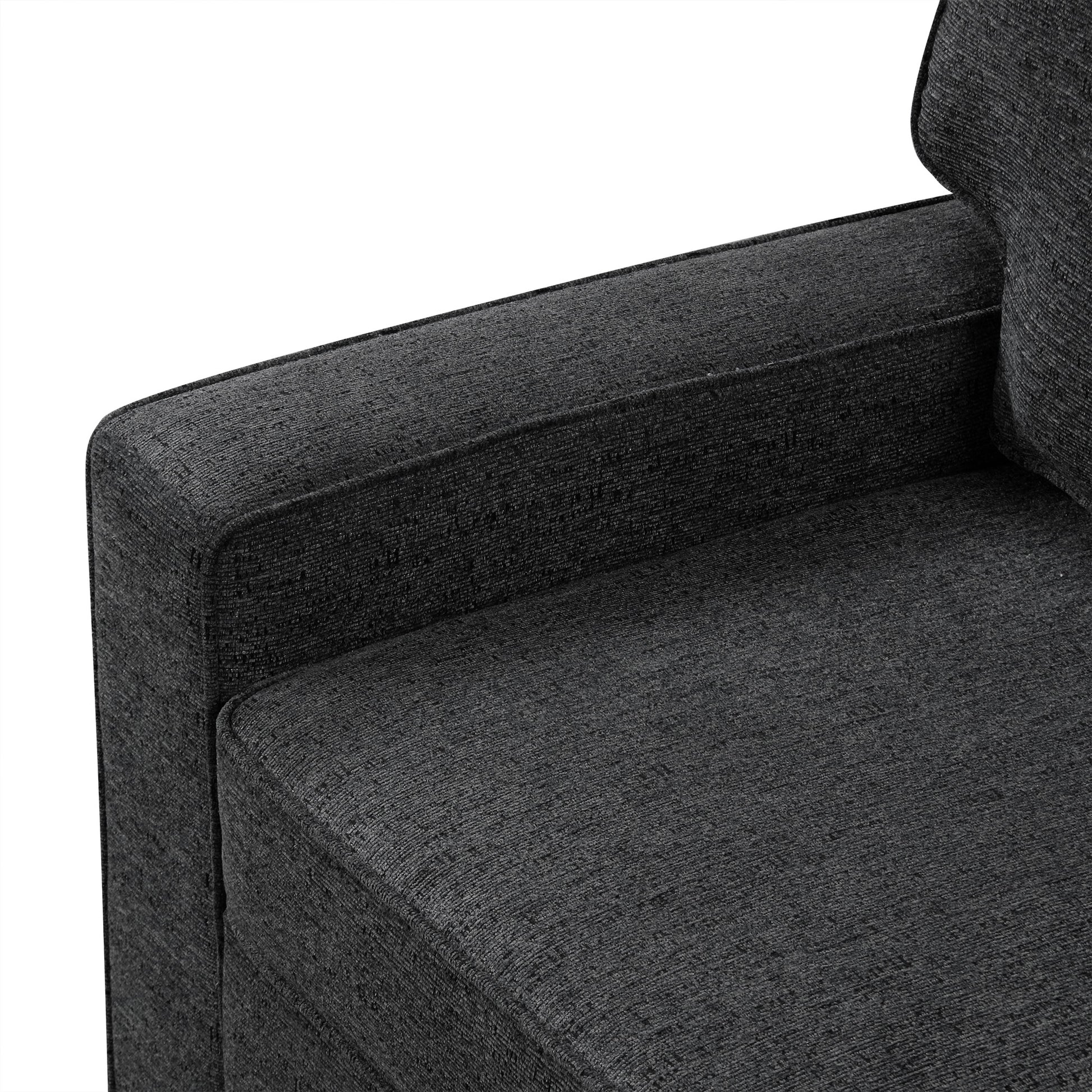 Closeup of a charcoal grey fabric sofa armrest showing textured upholstery detail