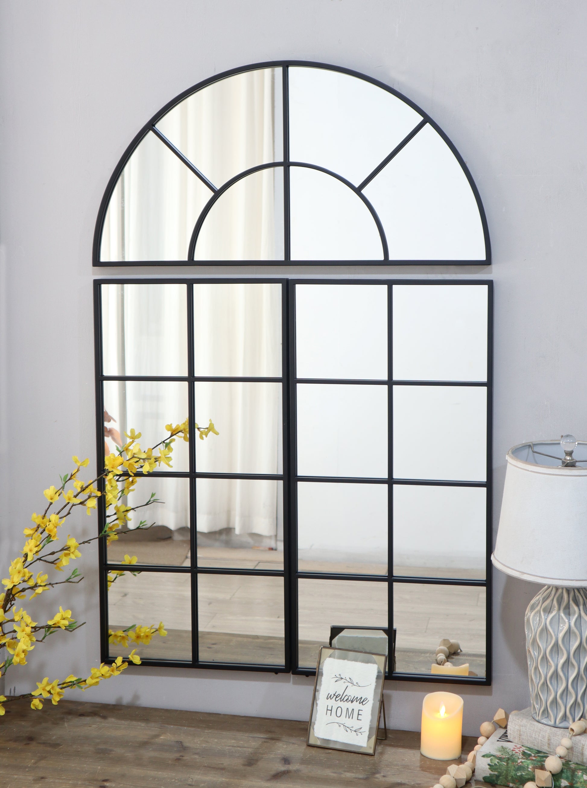 Arched window pane mirror with black metal frame perfect for entryway decor