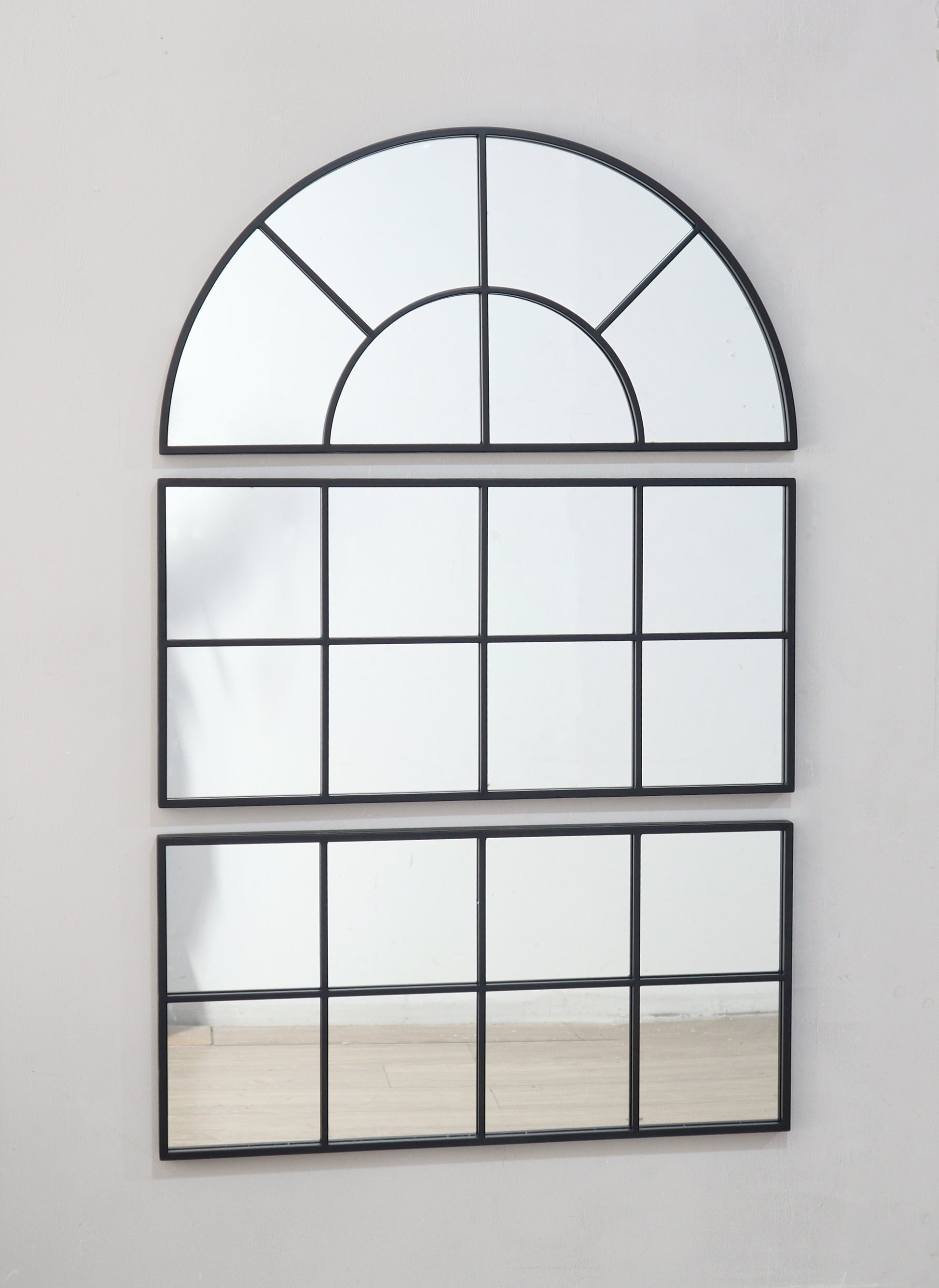 Arched industrial mirror with black frame ideal for entryway decor