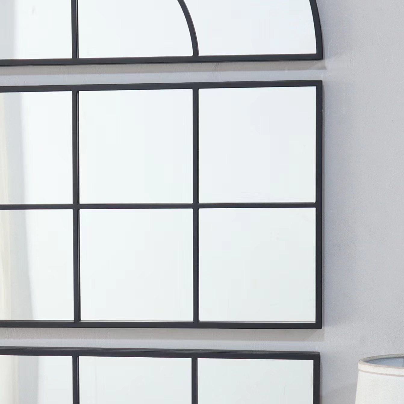 Black metal grid mirror with multiple pane sections ideal for industrial decor