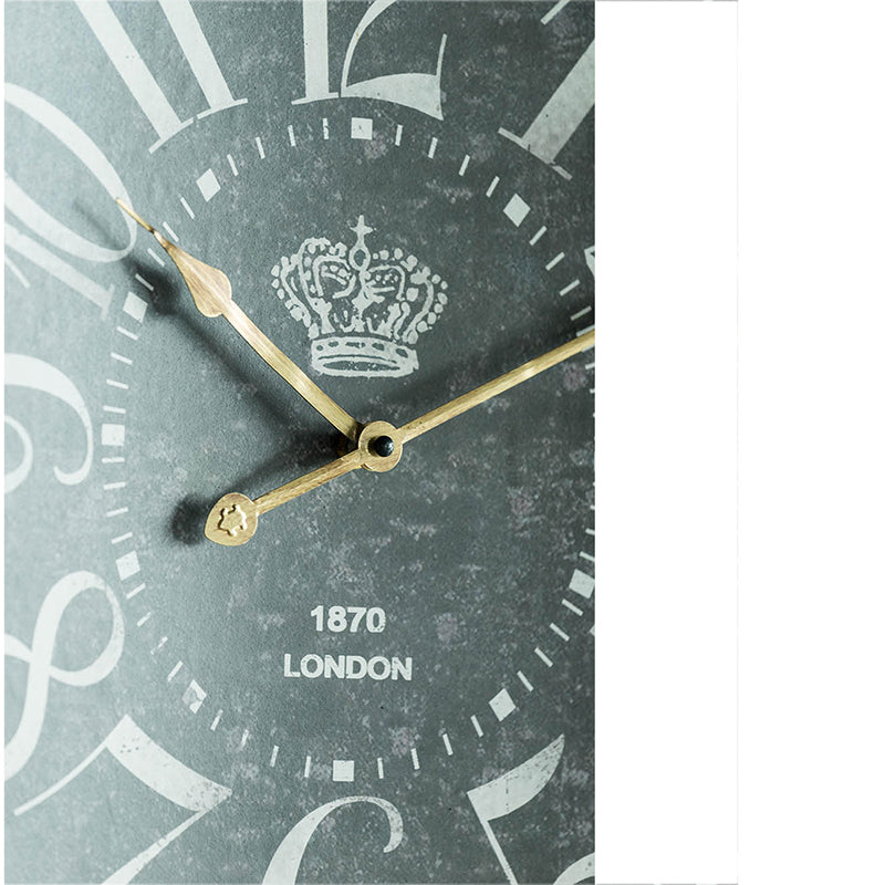 Closeup of a vintage wall clock face with Roman numerals gold hands and a crown emblem