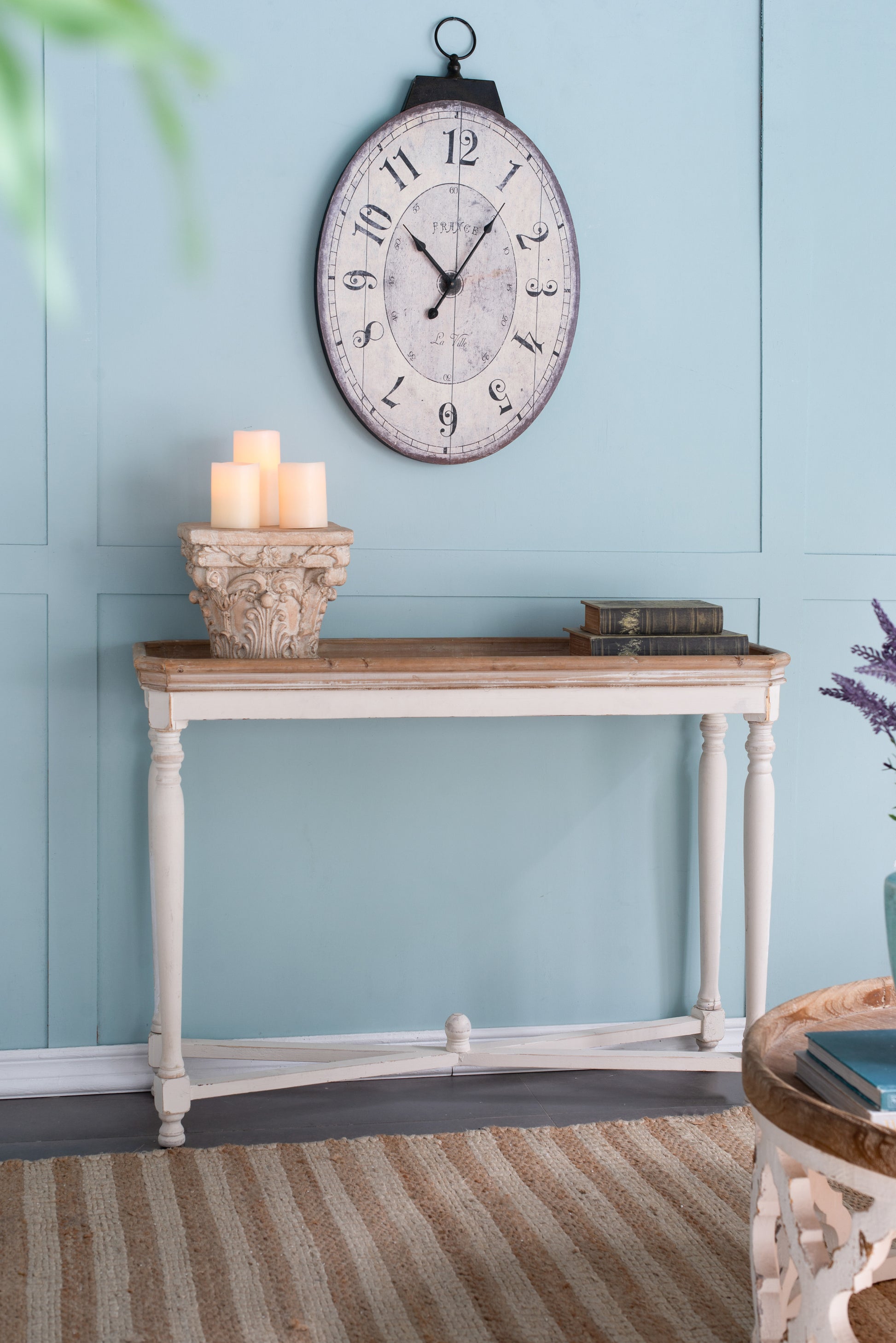 Antique oval wall clock with distressed finish and Roman numerals