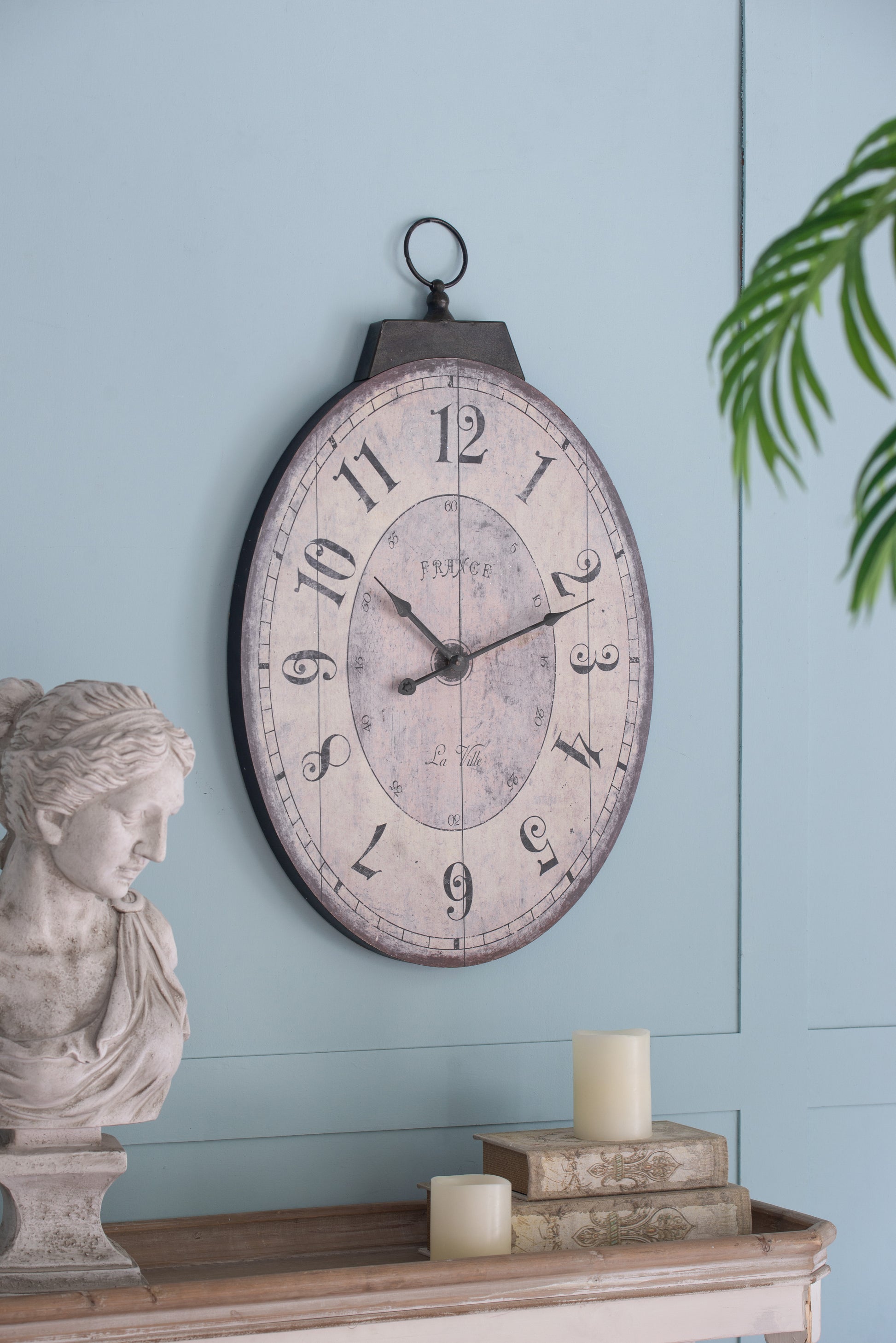 Vintage oval wall clock with distressed France face and Roman numerals