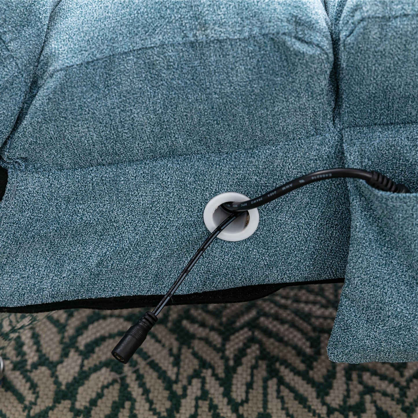 Blue fabric recliner with power cord routed through grommet