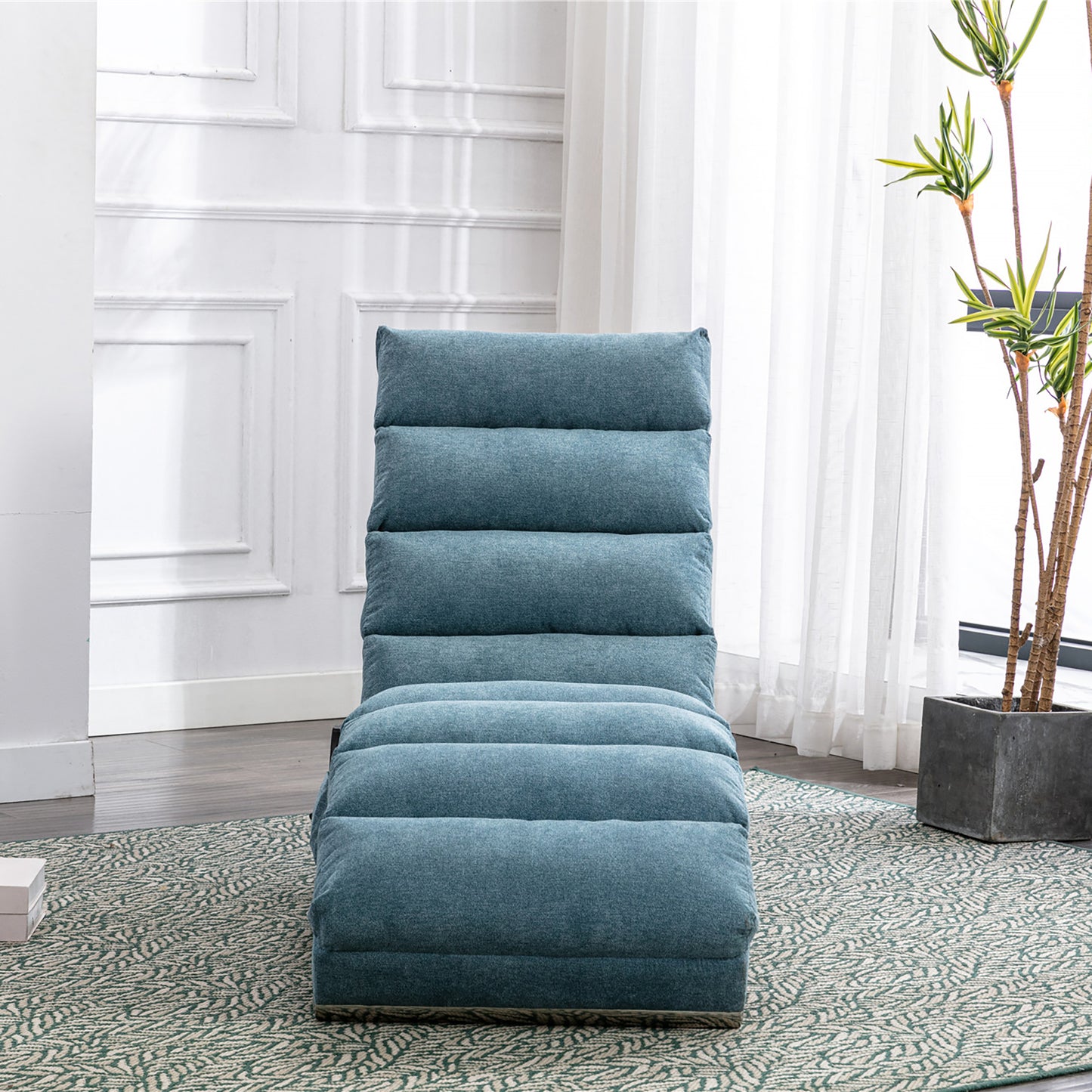 Teal blue fabric floor chair with plush horizontal cushioning adjustable for relaxation