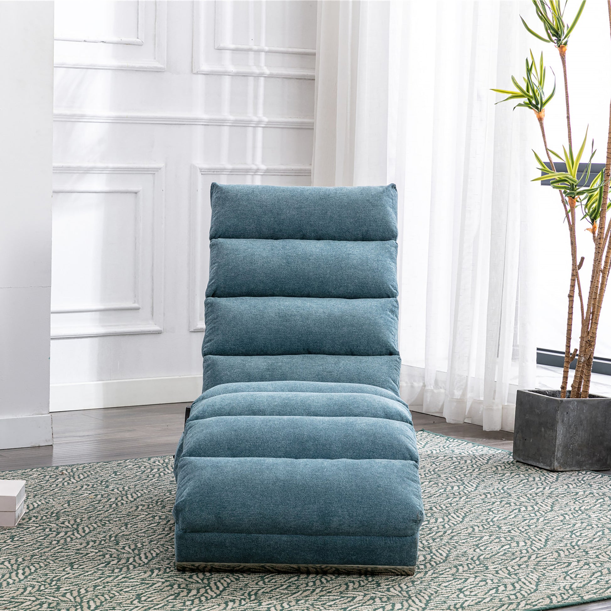 Teal blue fabric floor chair with plush horizontal cushioning adjustable for relaxation