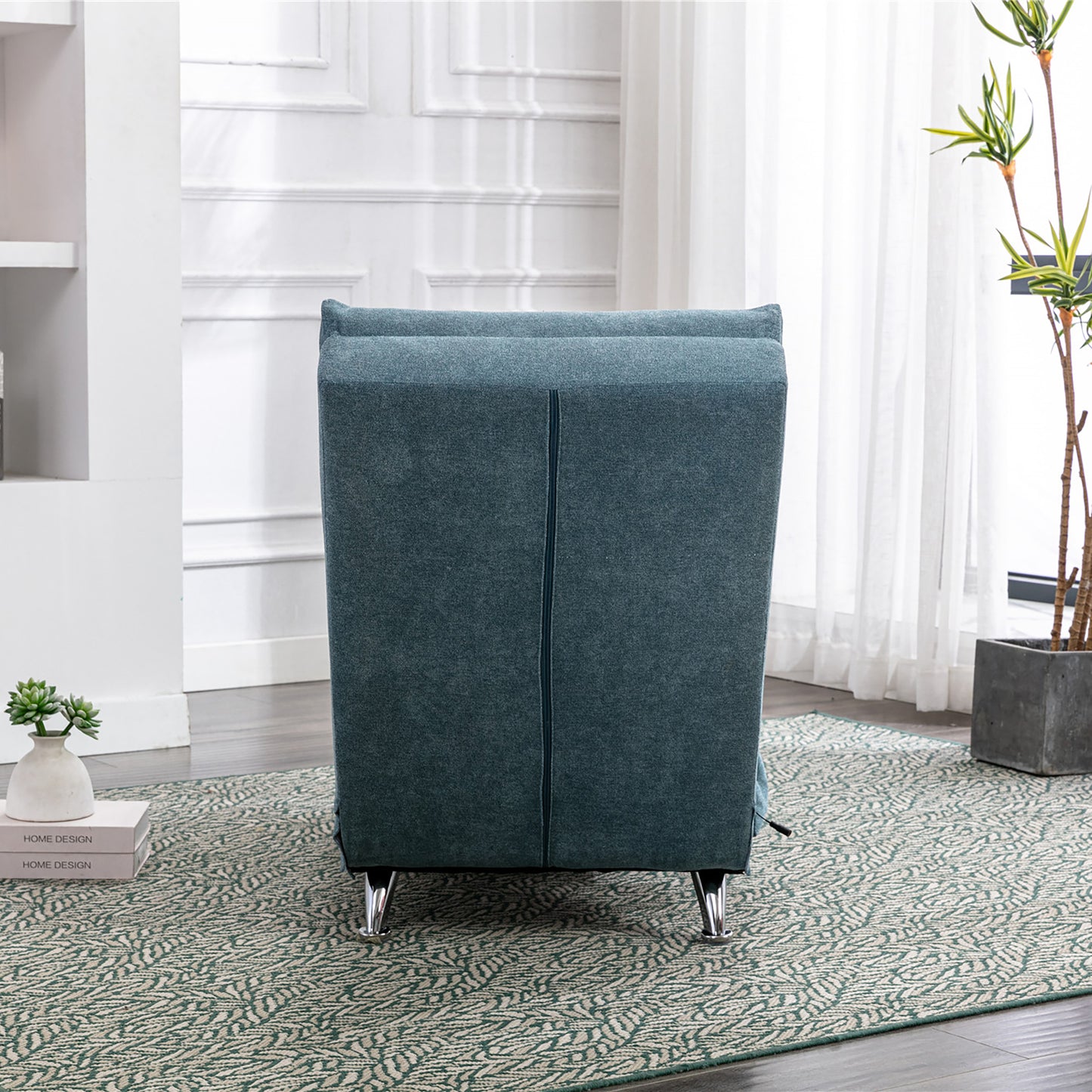 Teal upholstered accent chair with modern chrome legs and a clean vertical seam design