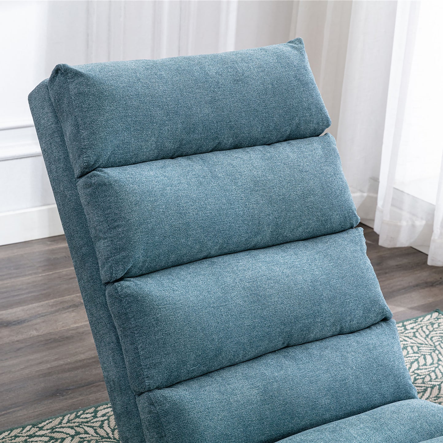 Closeup of a plush teal blue recliner chair with padded cushions