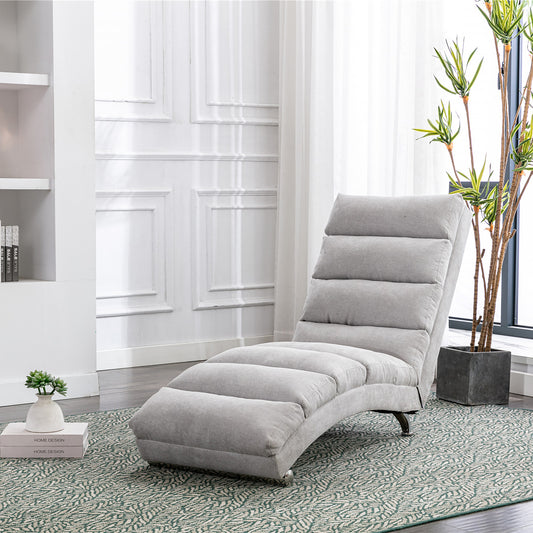 Light gray fabric chaise lounge with segmented cushioning and curved modern design