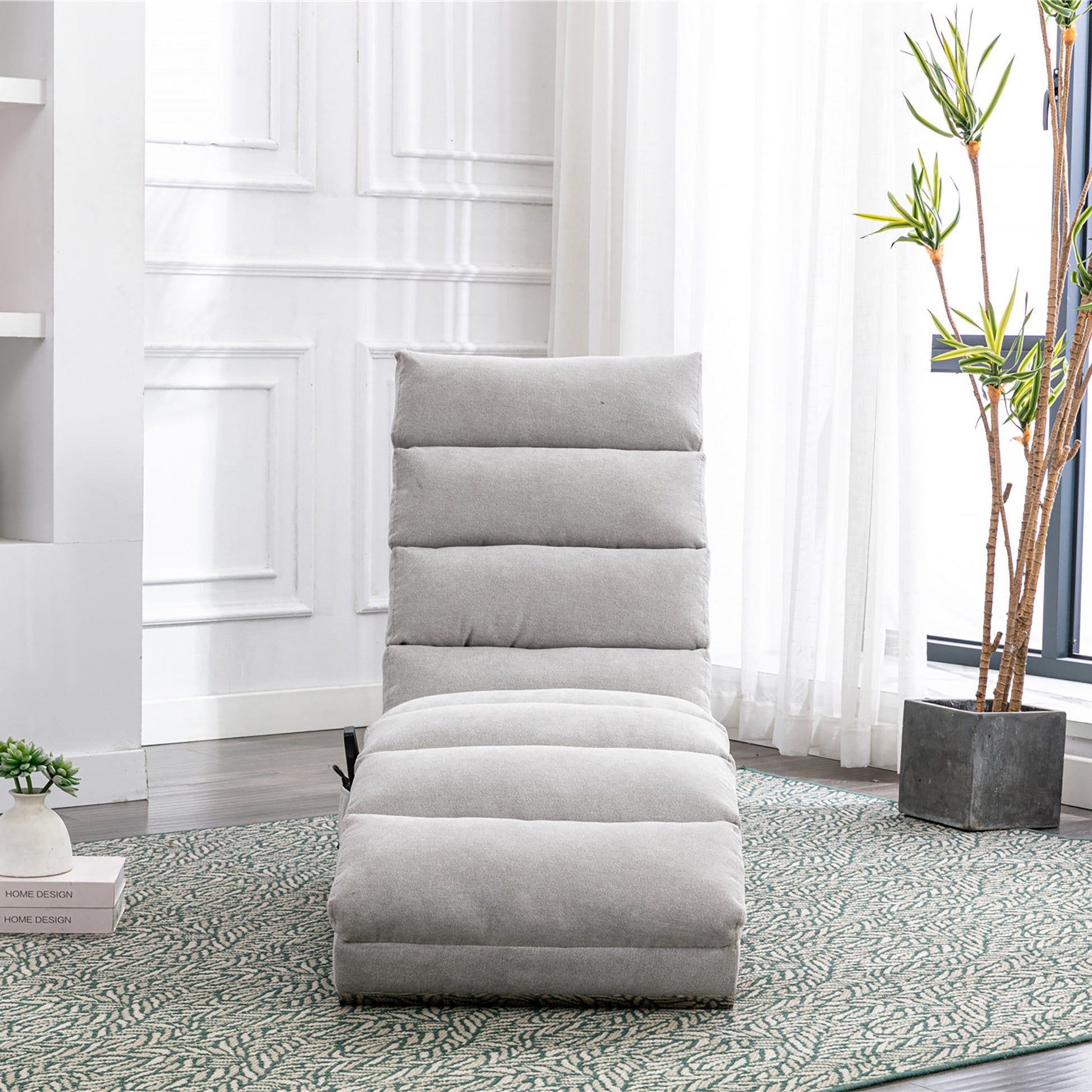Light grey upholstered chaise lounge chair with tufted seat and back