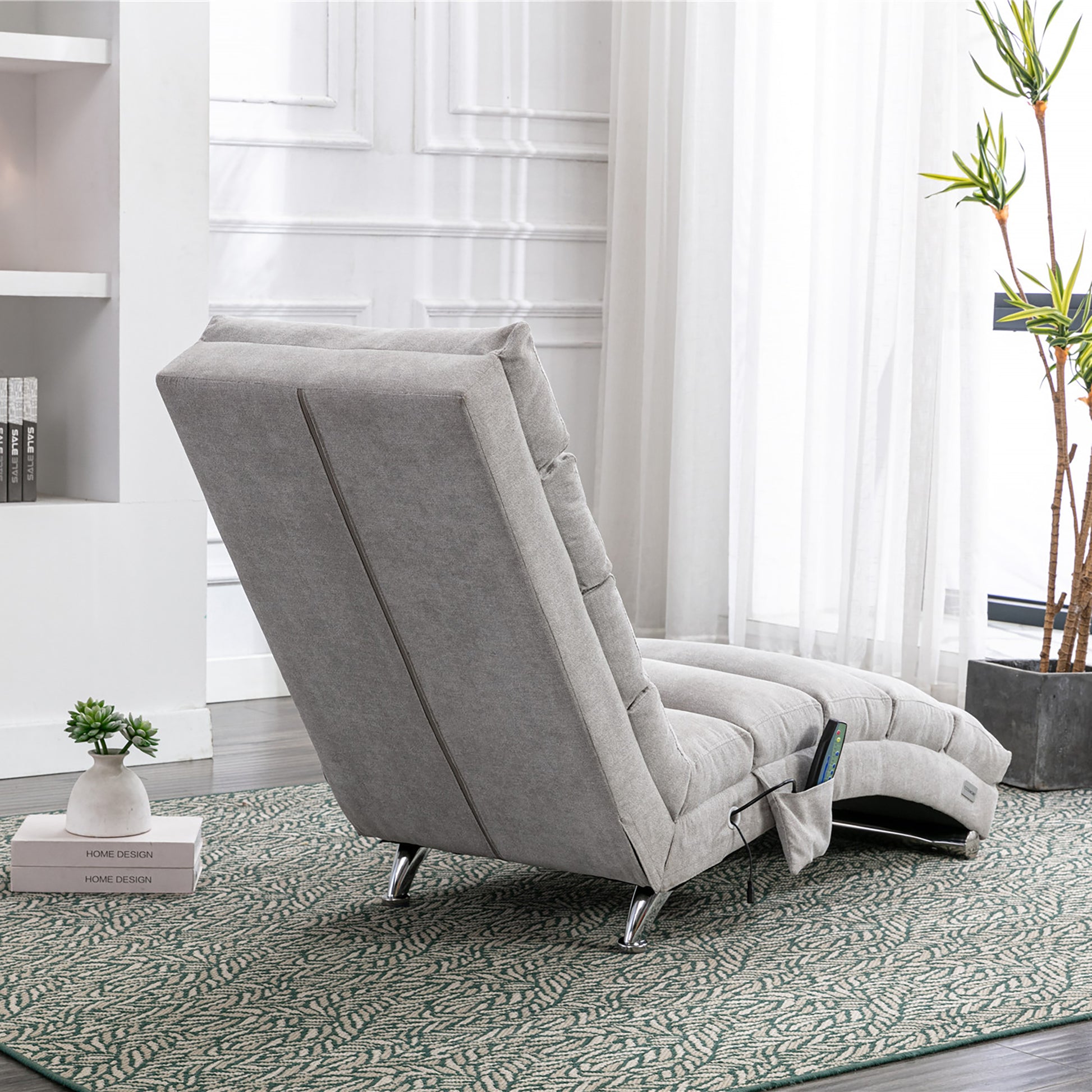 Grey fabric recliner with adjustable headrest and side pocket holding remote