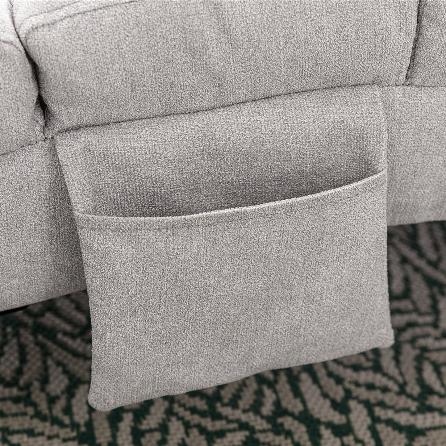 Closeup of a grey textured fabric recliner with a convenient side pocket